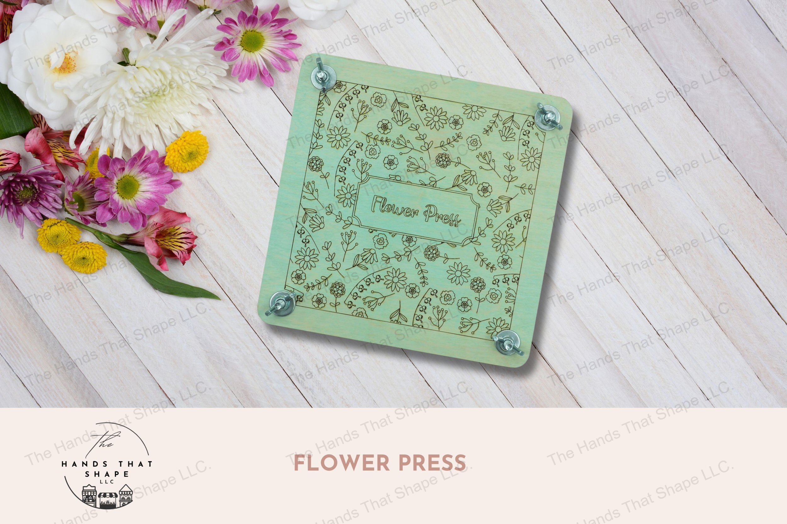 A decorative wooden flower press with laser-marked floral design, complete with cardboard and parchment layers for preserving blooms, blue version.