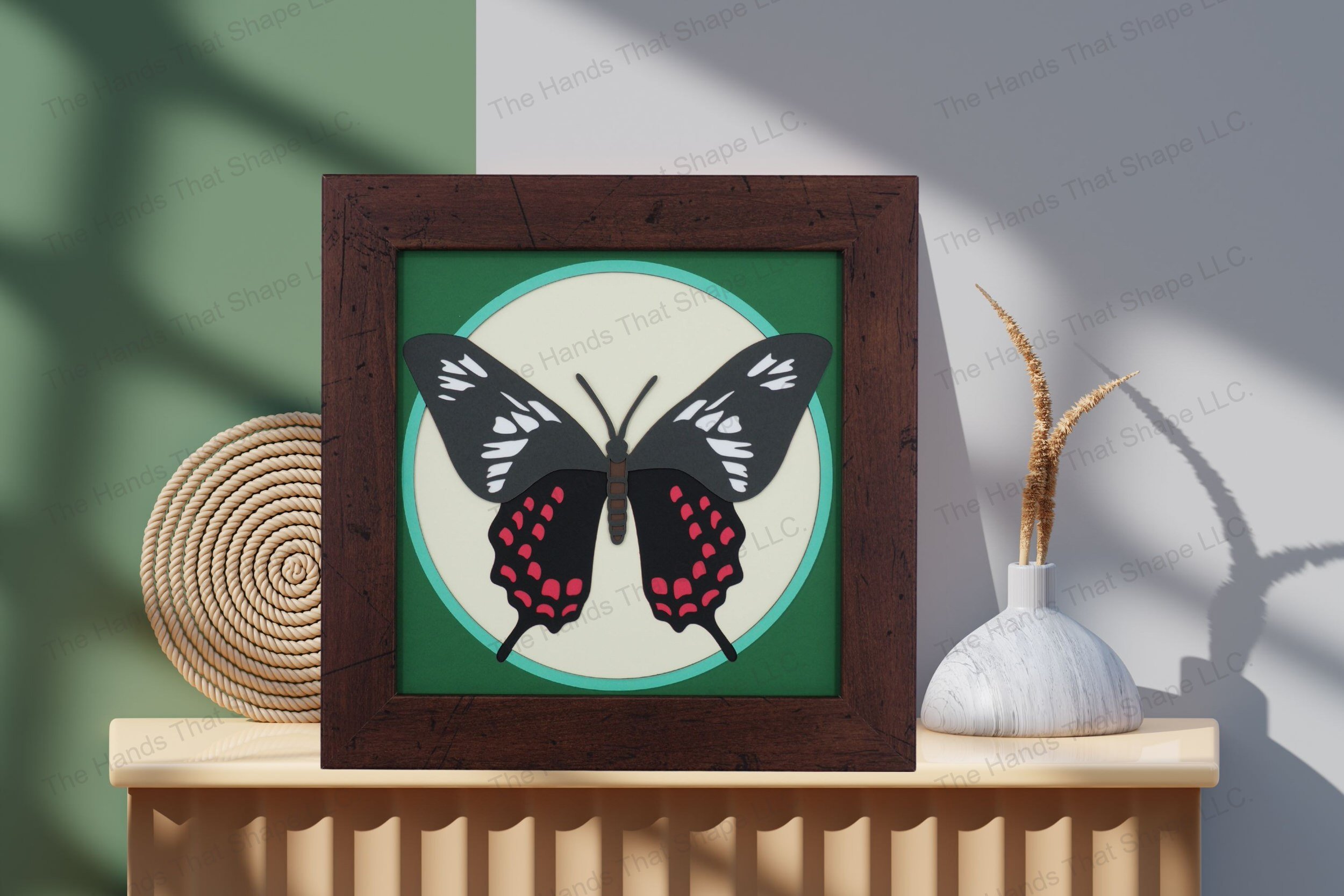 Admire this Crimson Rose Butterfly-themed cardstock artwork, displayed on a table, showcasing its layered depth and the dynamic beauty of its striking colors.