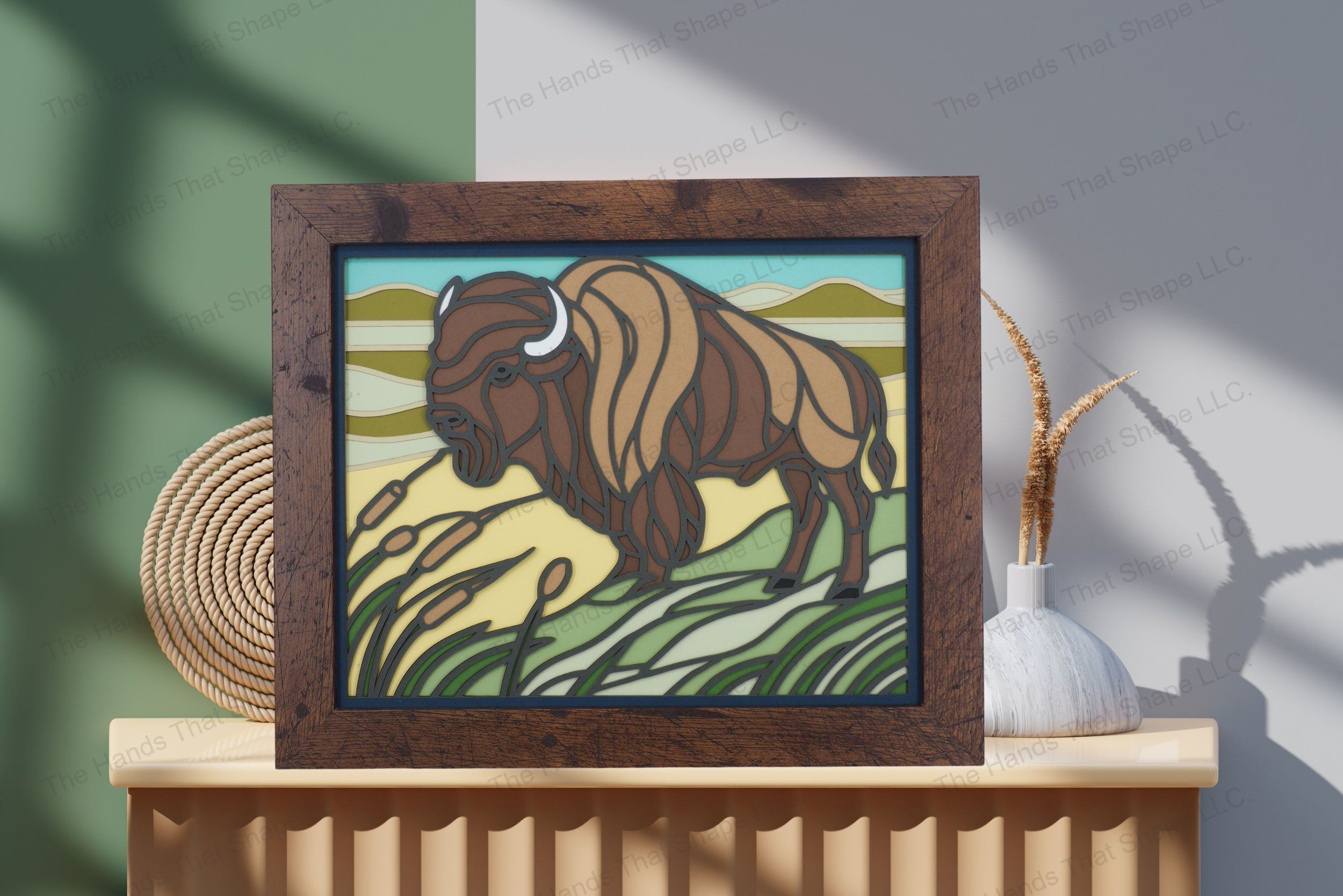 Behold this captivating bison-themed cardstock artwork, elegantly displayed on a table, showcasing its layered depth and vibrant portrayal of a prairie scene.