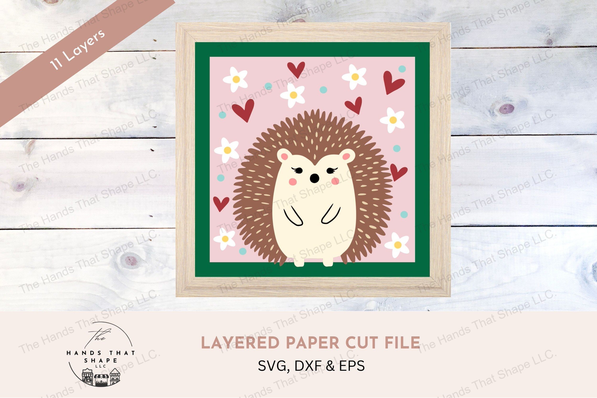 This layered cardstock design features a folksy hedgehog, surrounded by a vibrant array of flowers, dots, and hearts, creating a playful and inviting atmosphere