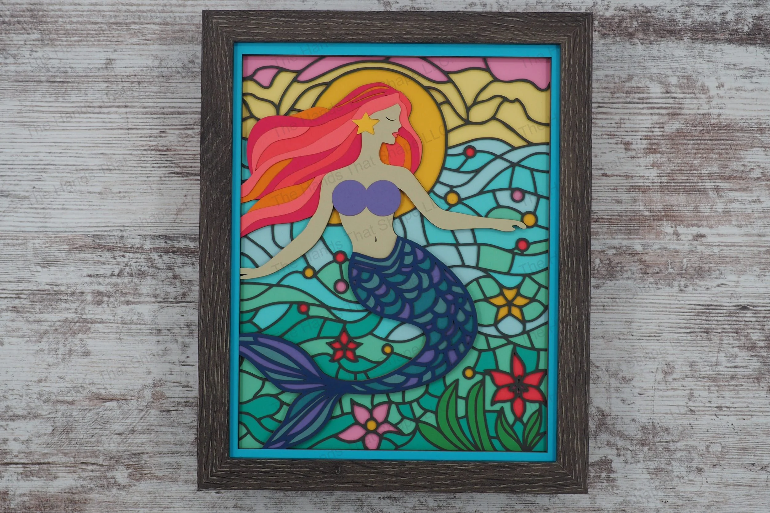 Immerse yourself in the underwater world with this layered paper shadowbox featuring a mermaid with flowing hair, with a stained glass-style backdrop.