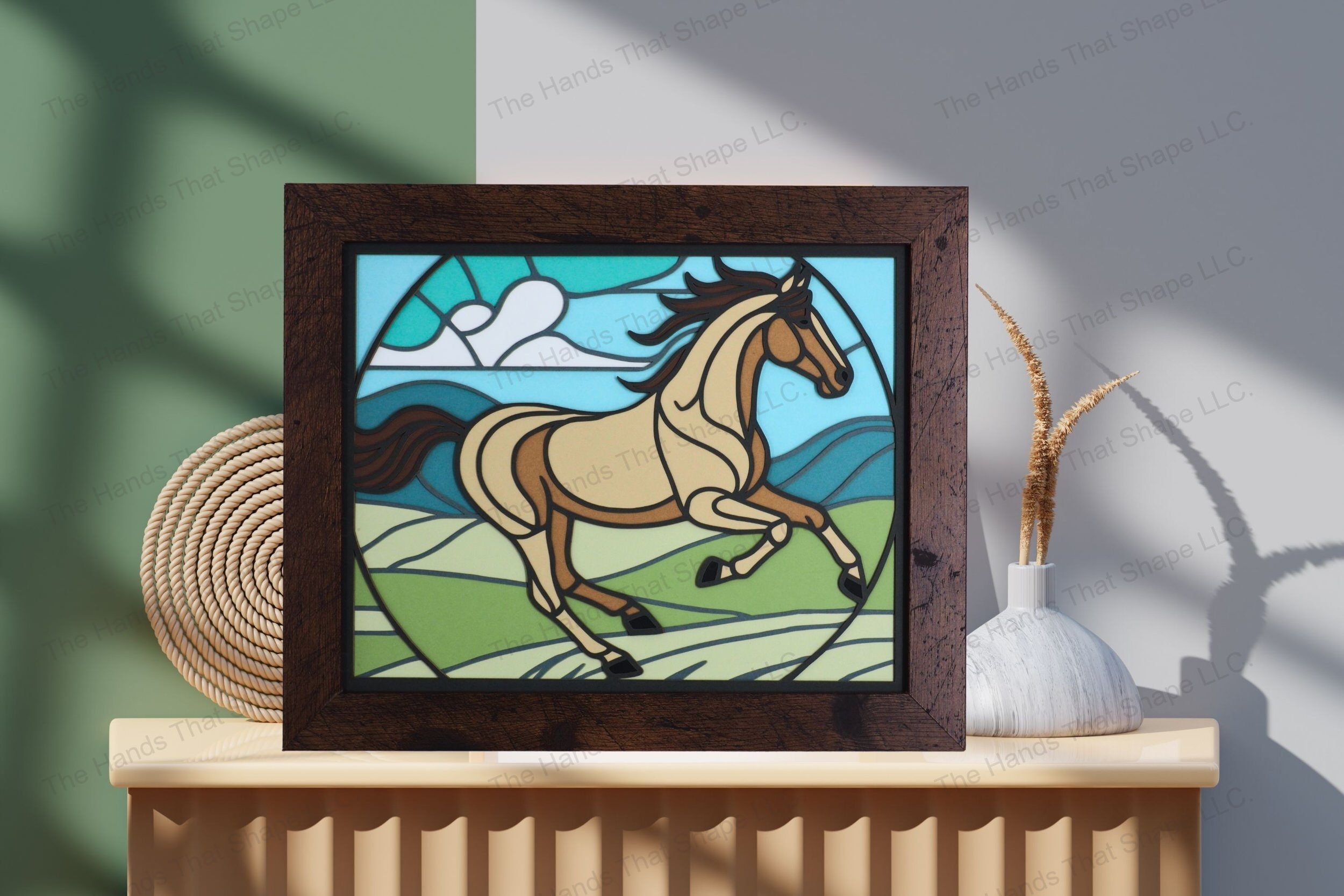 Admire this captivating cardstock artwork of a running horse, elegantly displayed on a table by a wall, showcasing its vibrant layers and intricate design.