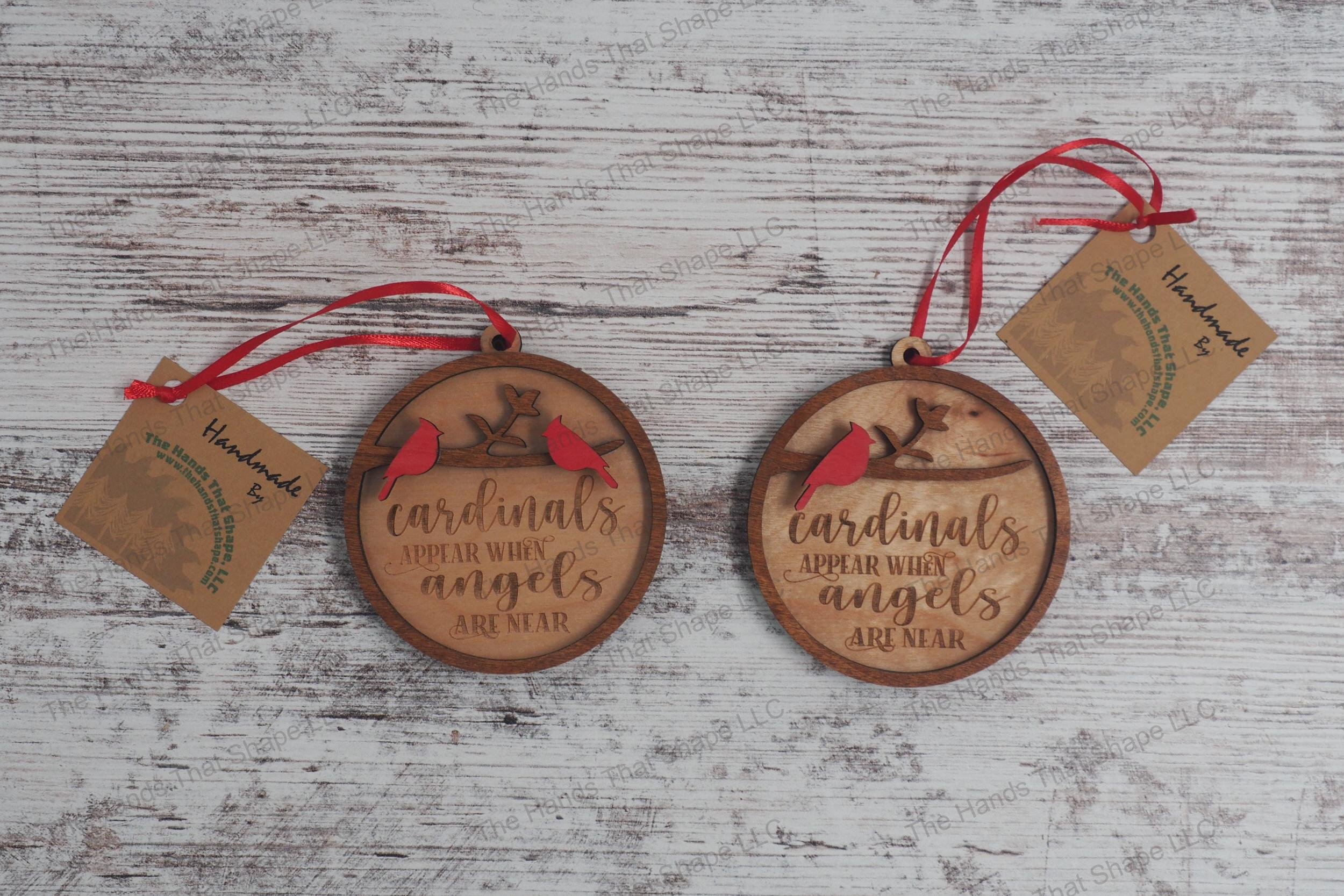 Wooden remembrance ornaments featuring the engraved phrase "Cardinals appear when angels are near" showing the one cardinal and two cardinal versions.