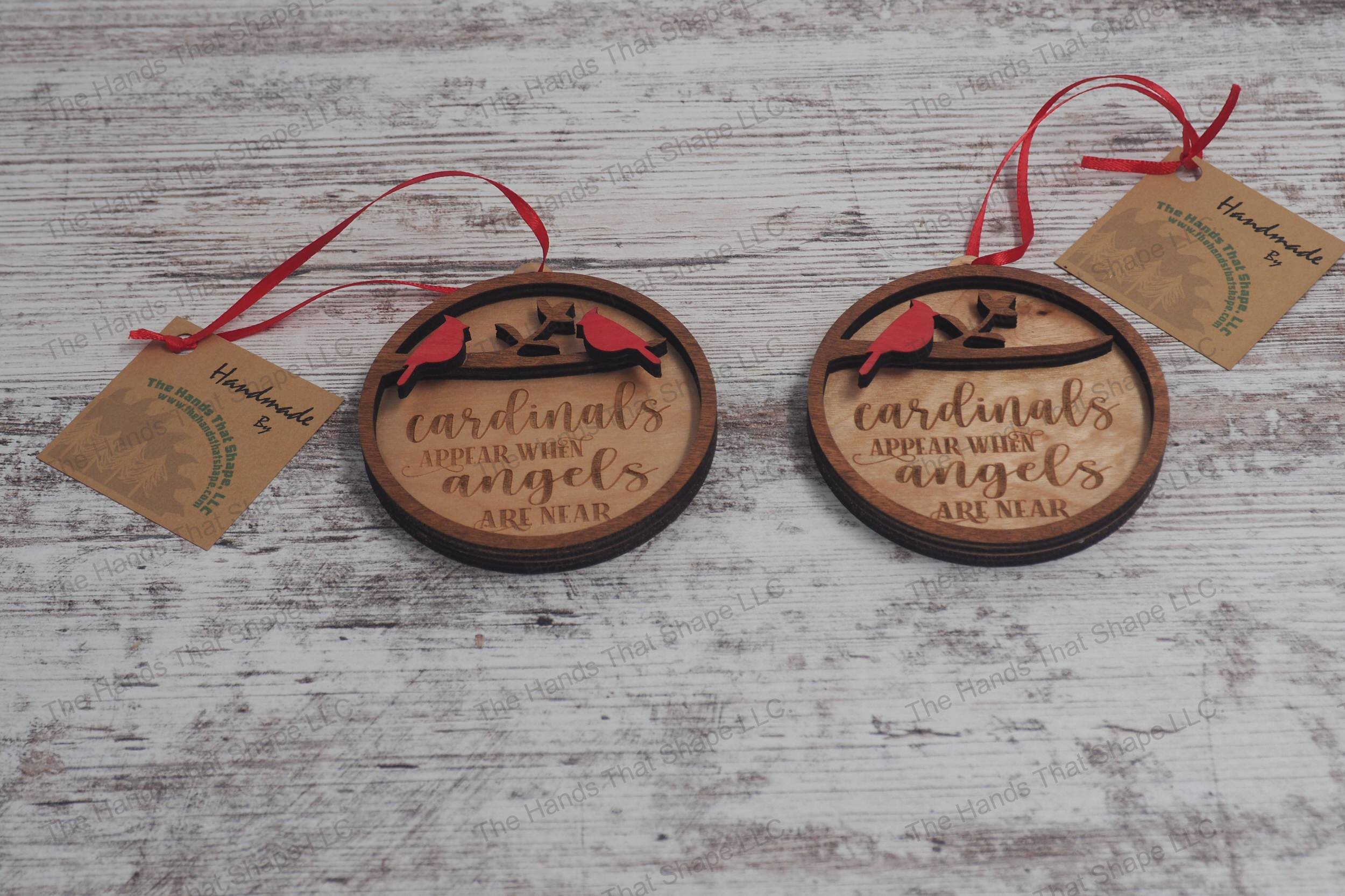Wooden remembrance ornaments featuring the engraved phrase "Cardinals appear when angels are near" showing the one cardinal and two cardinal versions.
