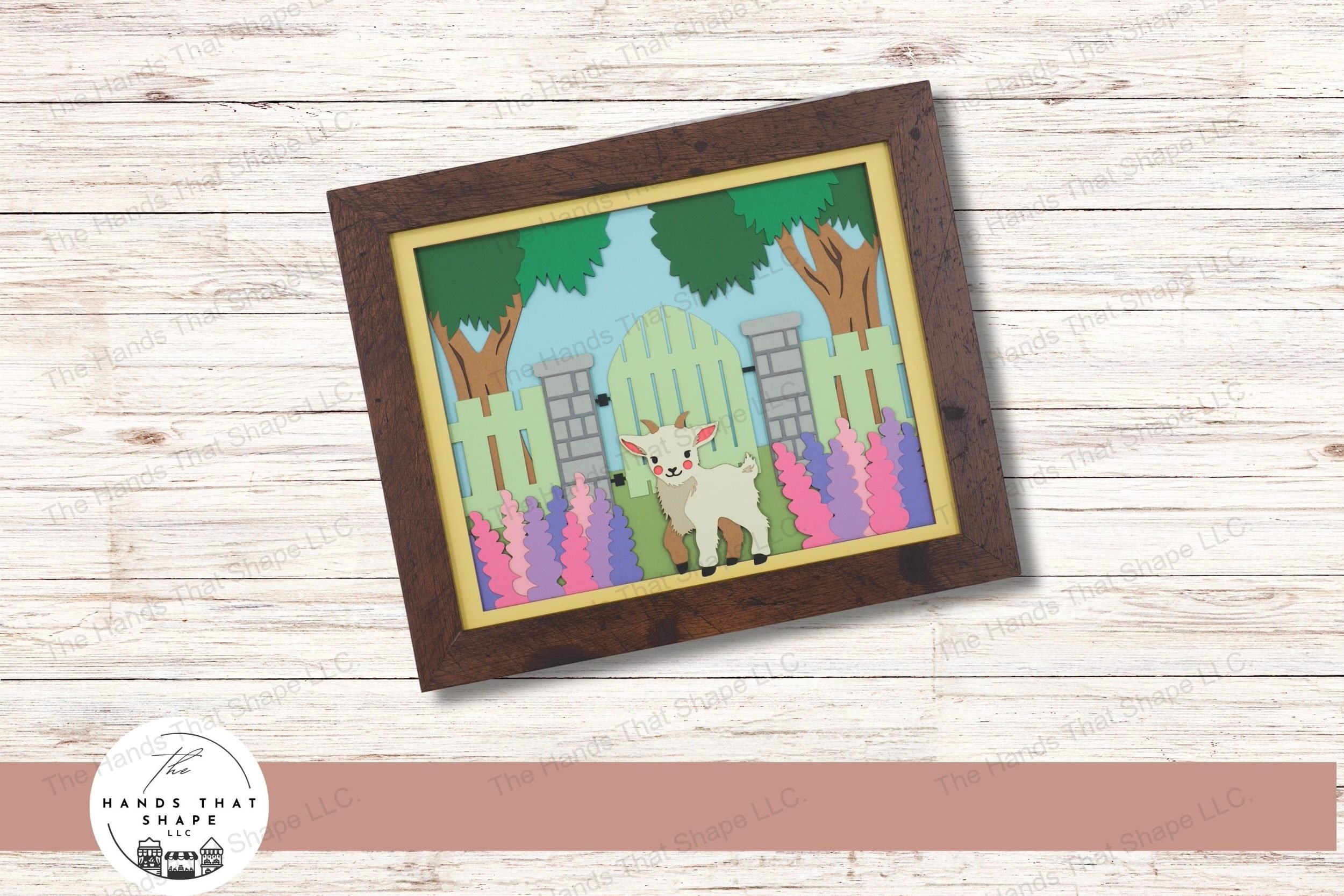 This 3d layered paper art piece captures a playful baby goat standing by a wooden gate, surrounded by stone pillars and blooming hyacinths.