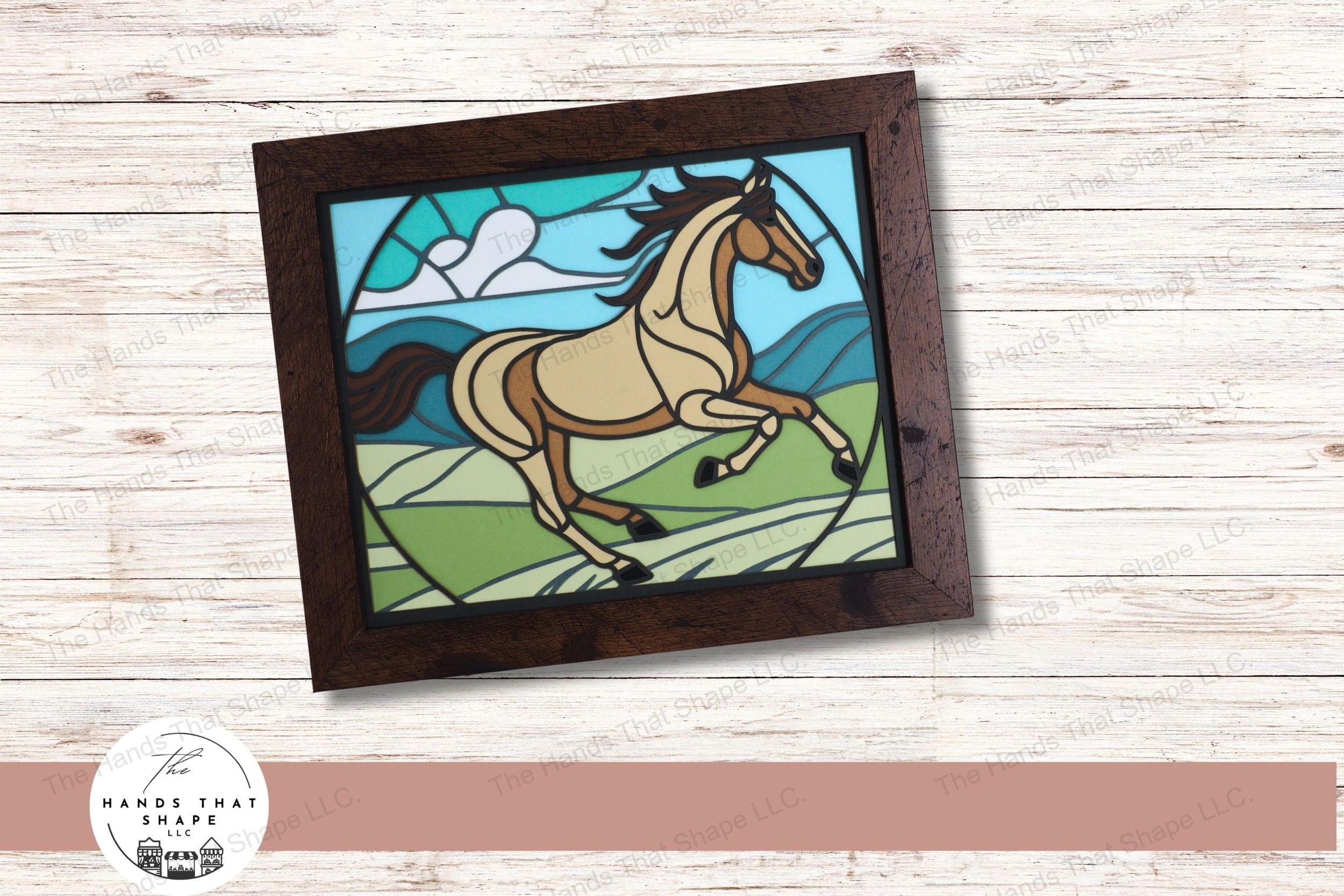 This layered art piece captures the majestic motion of a running horse, set against a hilly landscape and sky, creating a stunning stained glass effect.