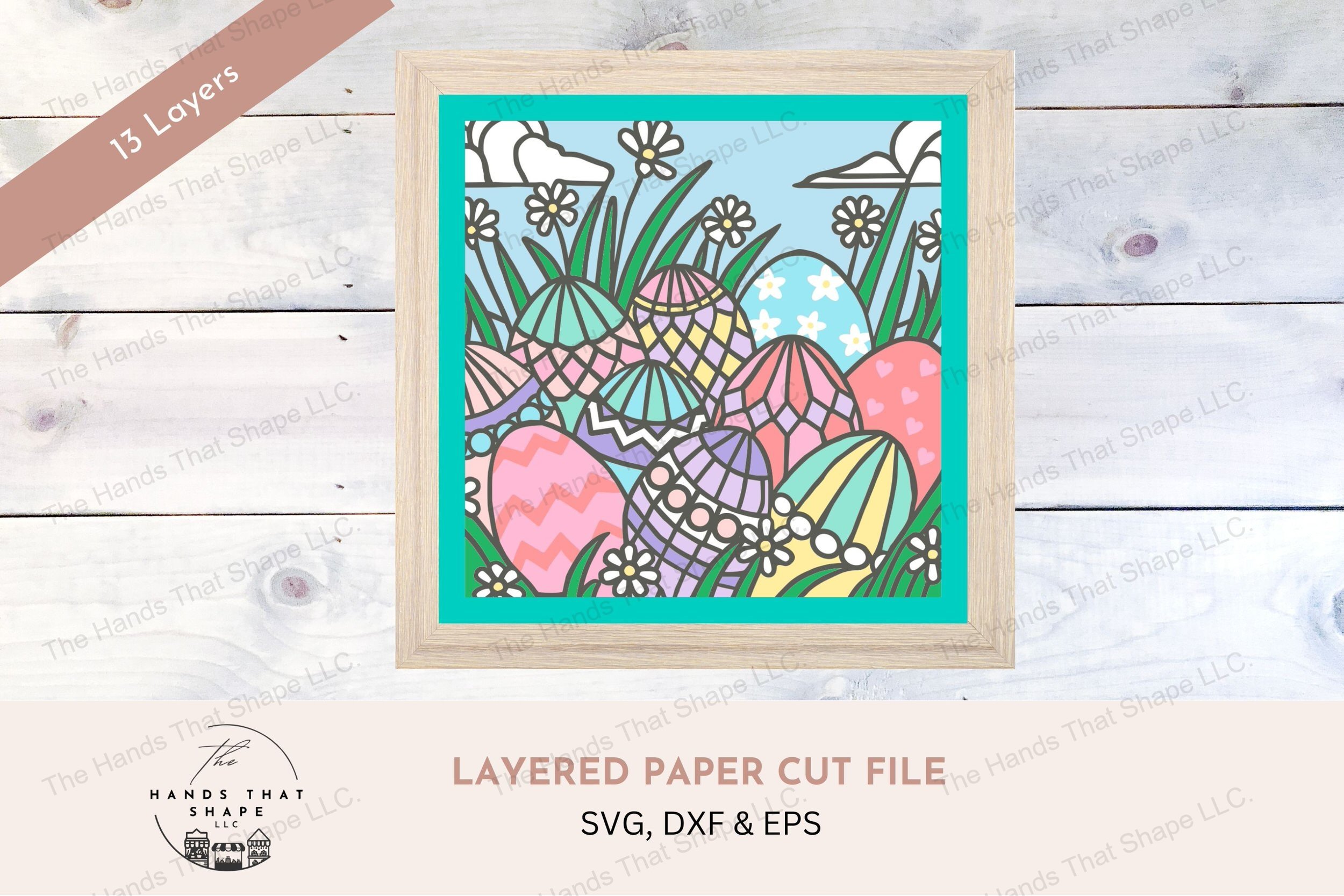 This layered cardstock art piece captures a delightful Easter scene, featuring decorated eggs nestled among daisies in the grass and set under a sky of clouds.