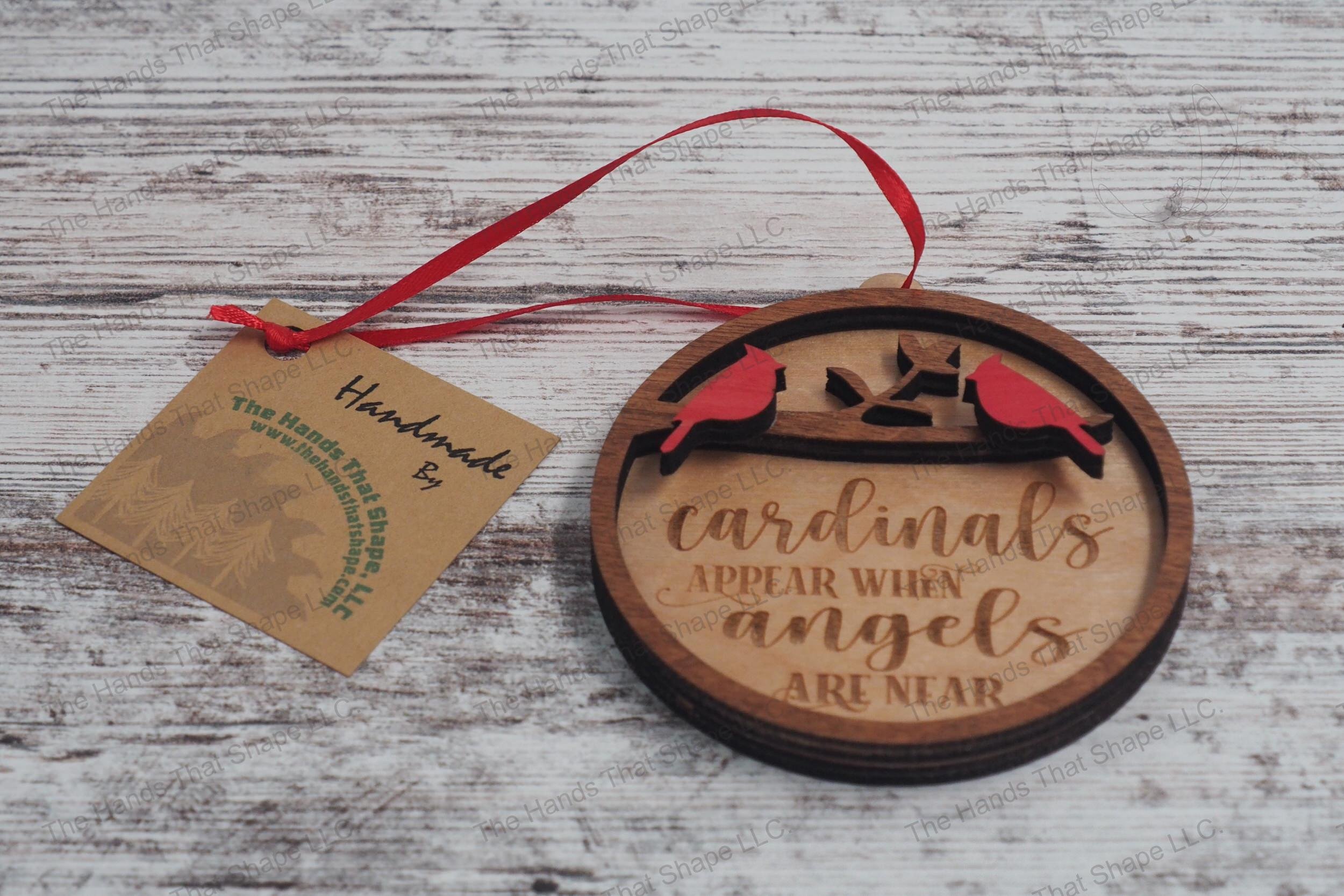 Wooden remembrance ornament featuring the engraved phrase "Cardinals appear when angels are near" along with two cardinals.