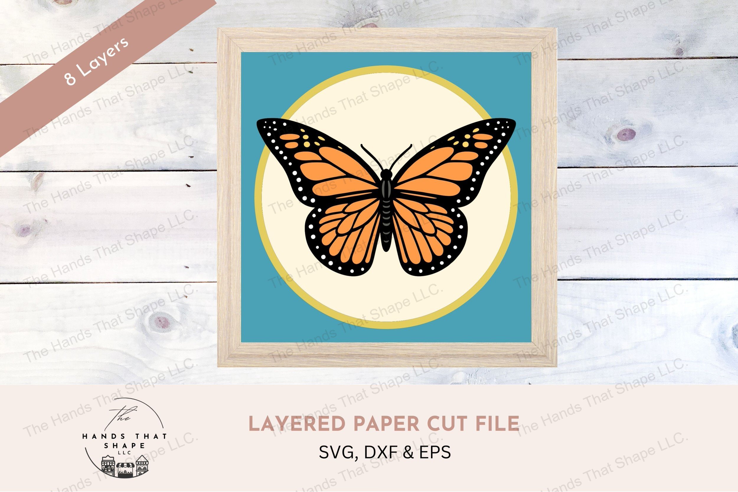 This layered cardstock art piece captures the detail of a Monarch butterfly's fully spread wings, showcasing vibrant colors and intricate patterns.