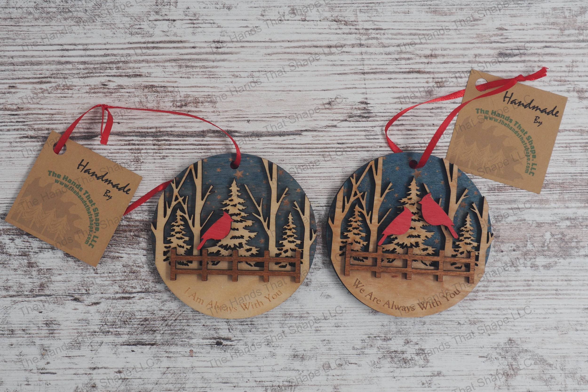 Honor loved ones with our wooden remembrance ornaments, featuring starry skies, a serene forest, and cardinals perched above a fence, with heartfelt messages.