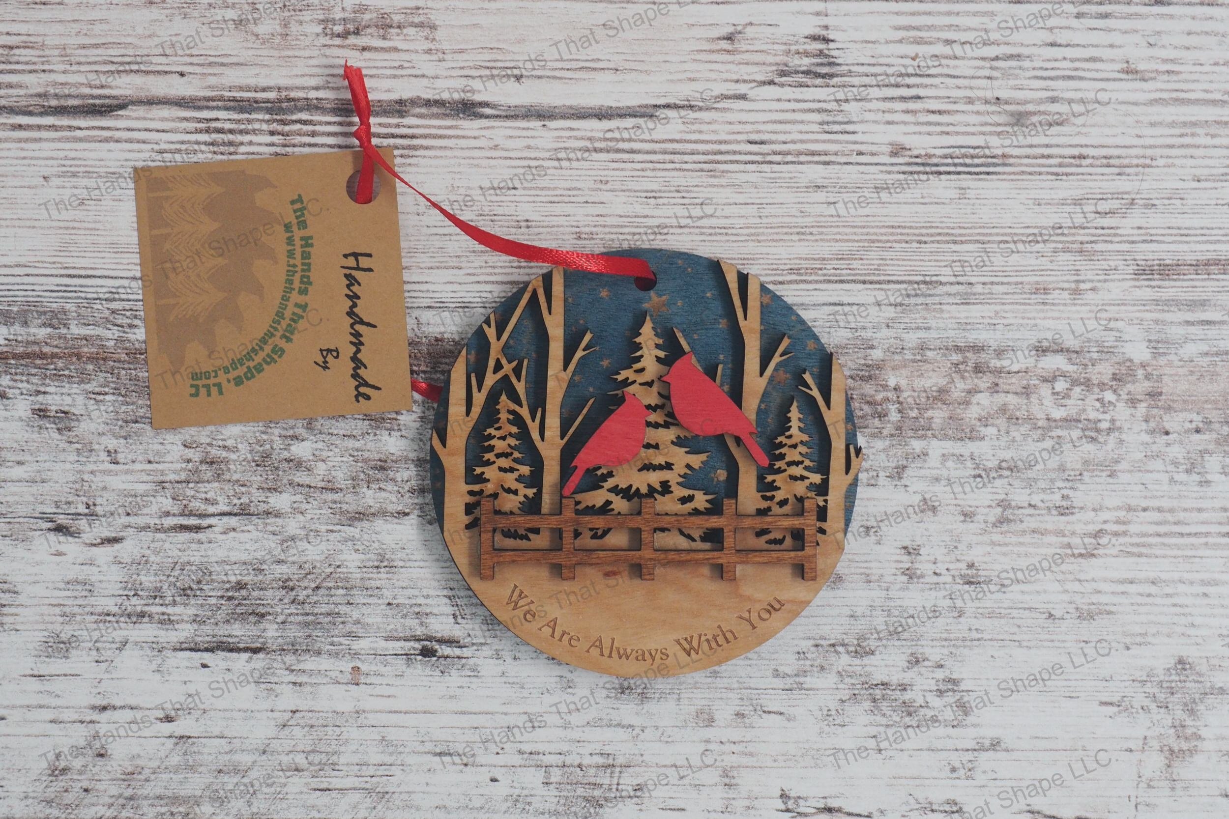 Three-layer wooden remembrance ornament, featuring starry skies, a serene forest, and two cardinals perched above a fence, with a heartfelt engraved message.