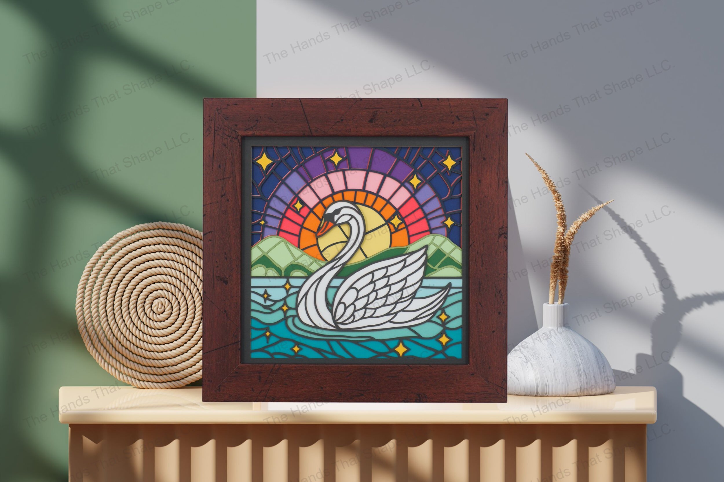 Admire this elegant swan-themed cardstock artwork, displayed on a table, where each layer combines to form a tranquil lake scene under a star-studded sunrise.