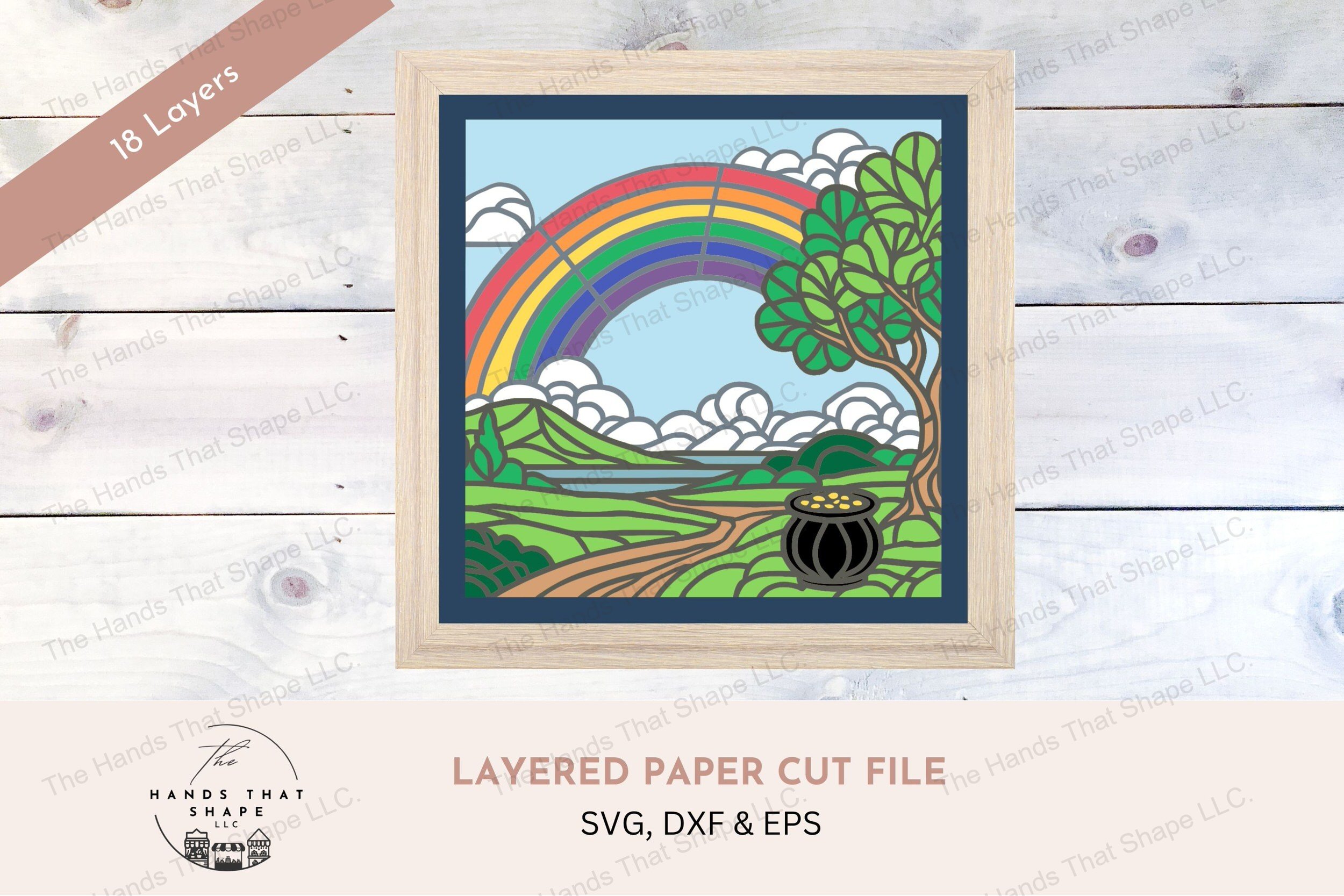 This layered cardstock art piece vividly captures a scenic pot of gold at the end of a rainbow, creating a charming and colorful display.
