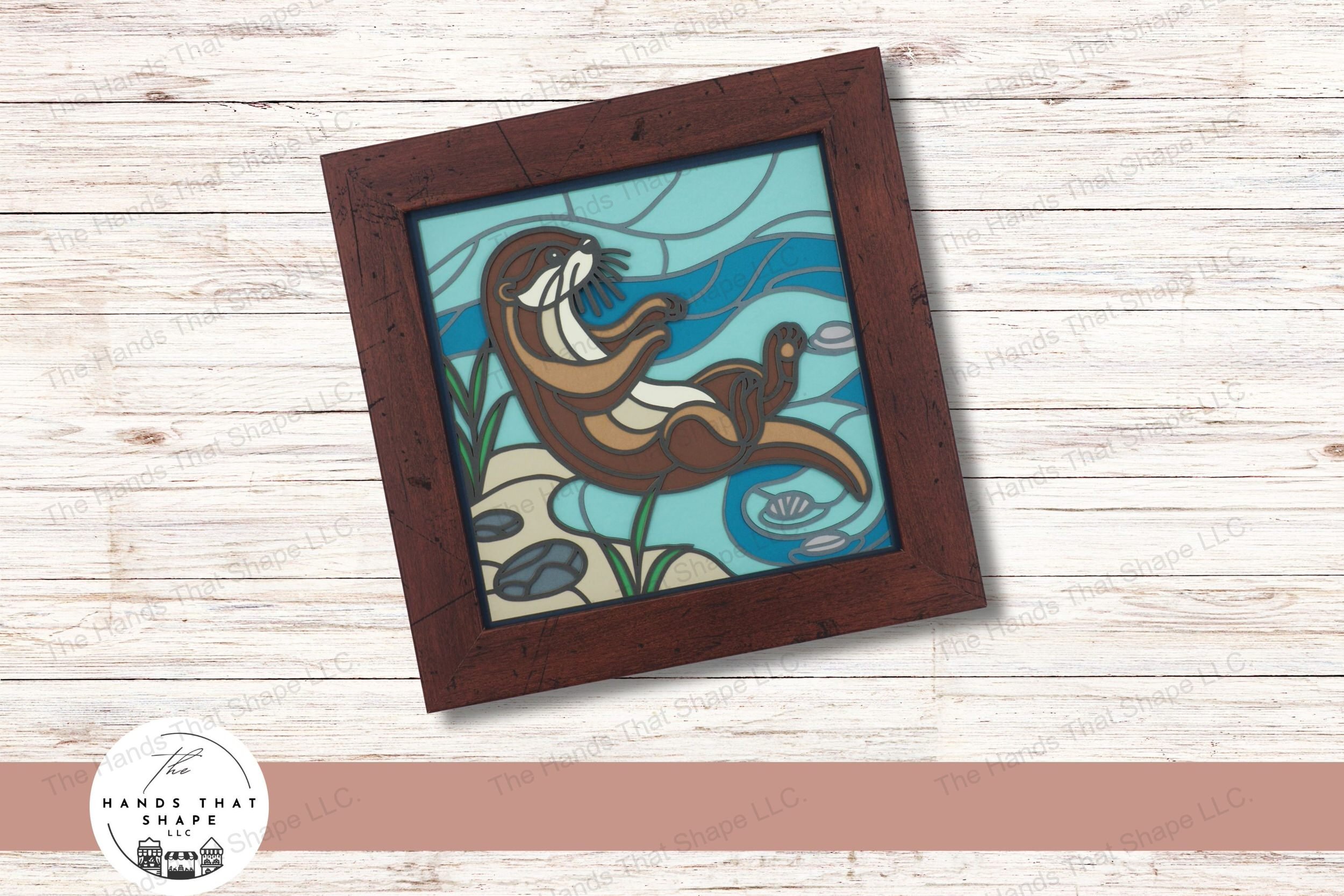This layered cardstock art piece vividly captures a playful otter lounging by the water's edge, crafted with vibrant detail to bring the scene to life.