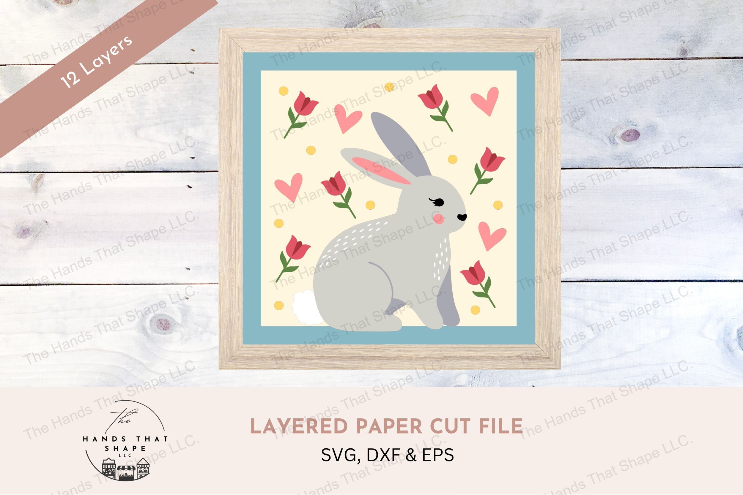 This layered cardstock art piece beautifully captures a whimsical folksy bunny, surrounded by a colorful array of tulips, hearts, and decorative dots.