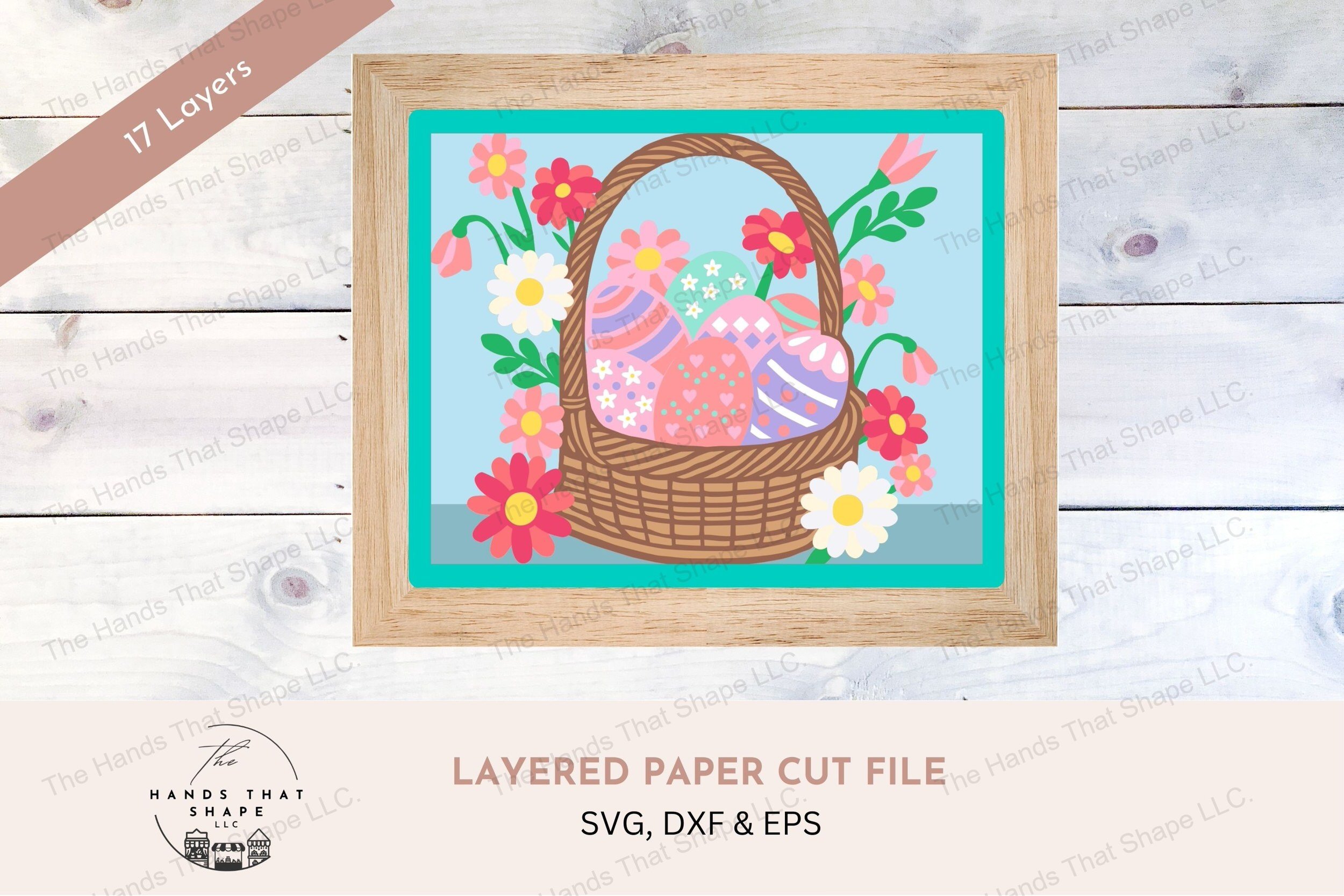 This layered cardstock art piece showcases a beautifully woven Easter basket filled with decorated eggs and surrounded by a burst of colorful spring flowers.