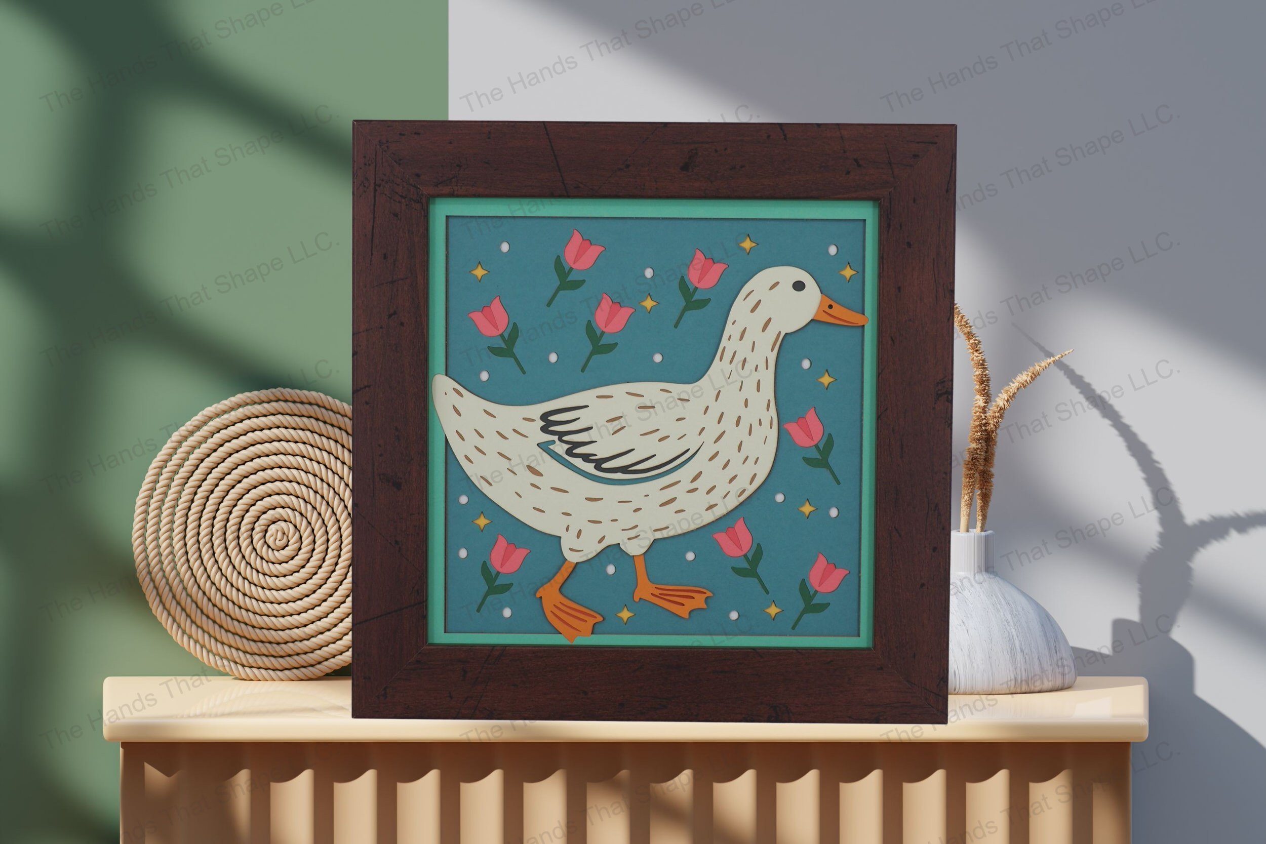 Admire this folksy duck-themed cardstock artwork, thoughtfully displayed on a table by a wall, showcasing its vibrant layers and playful rural charm.