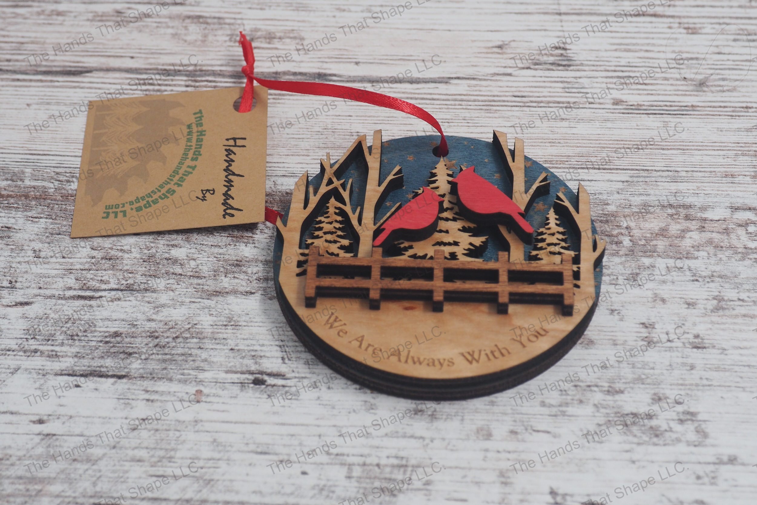 Three-layer wooden remembrance ornament, featuring starry skies, a serene forest, and two cardinals perched above a fence, with a heartfelt engraved message.