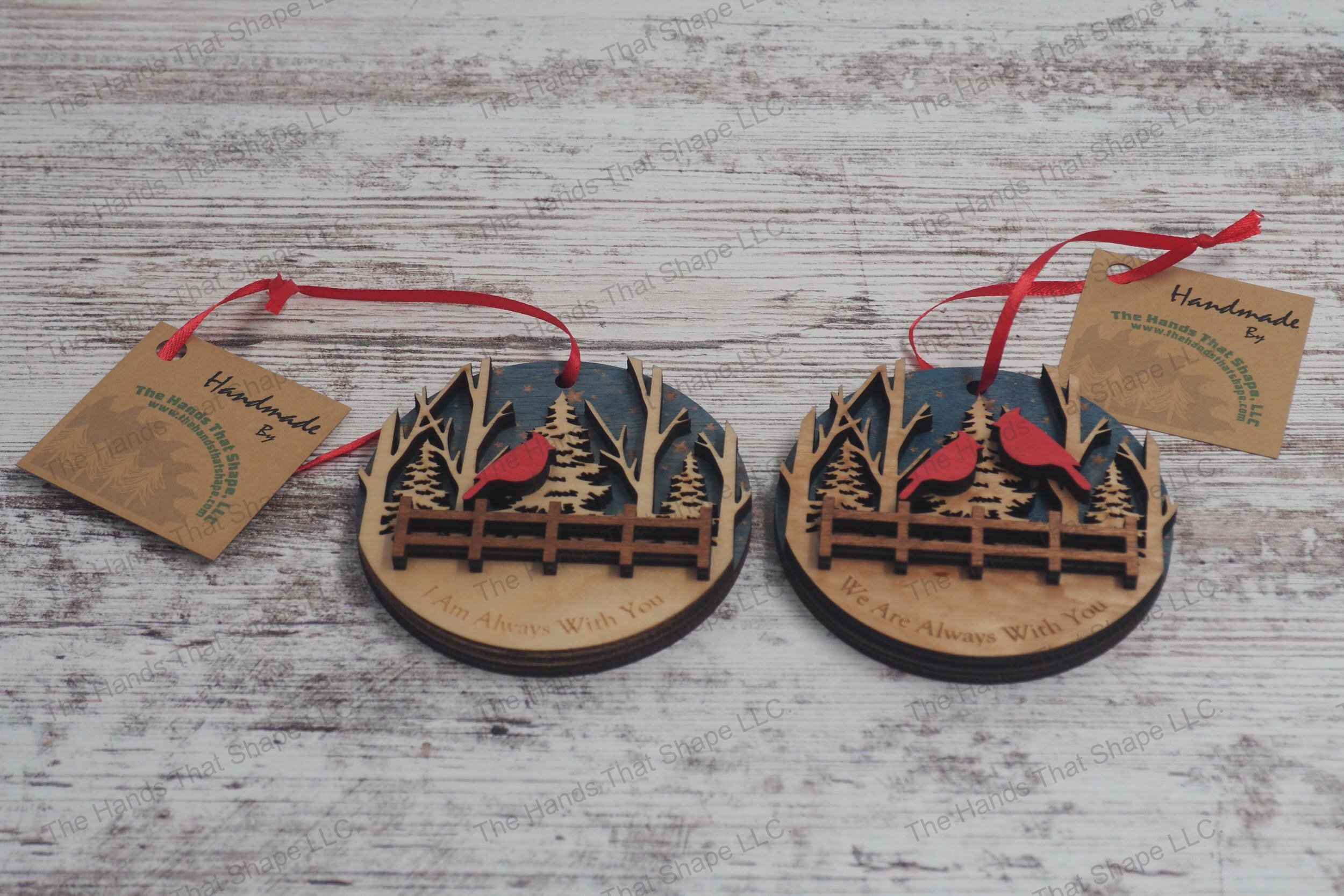 Honor loved ones with our wooden remembrance ornaments, featuring starry skies, a serene forest, and cardinals perched above a fence, with heartfelt messages.