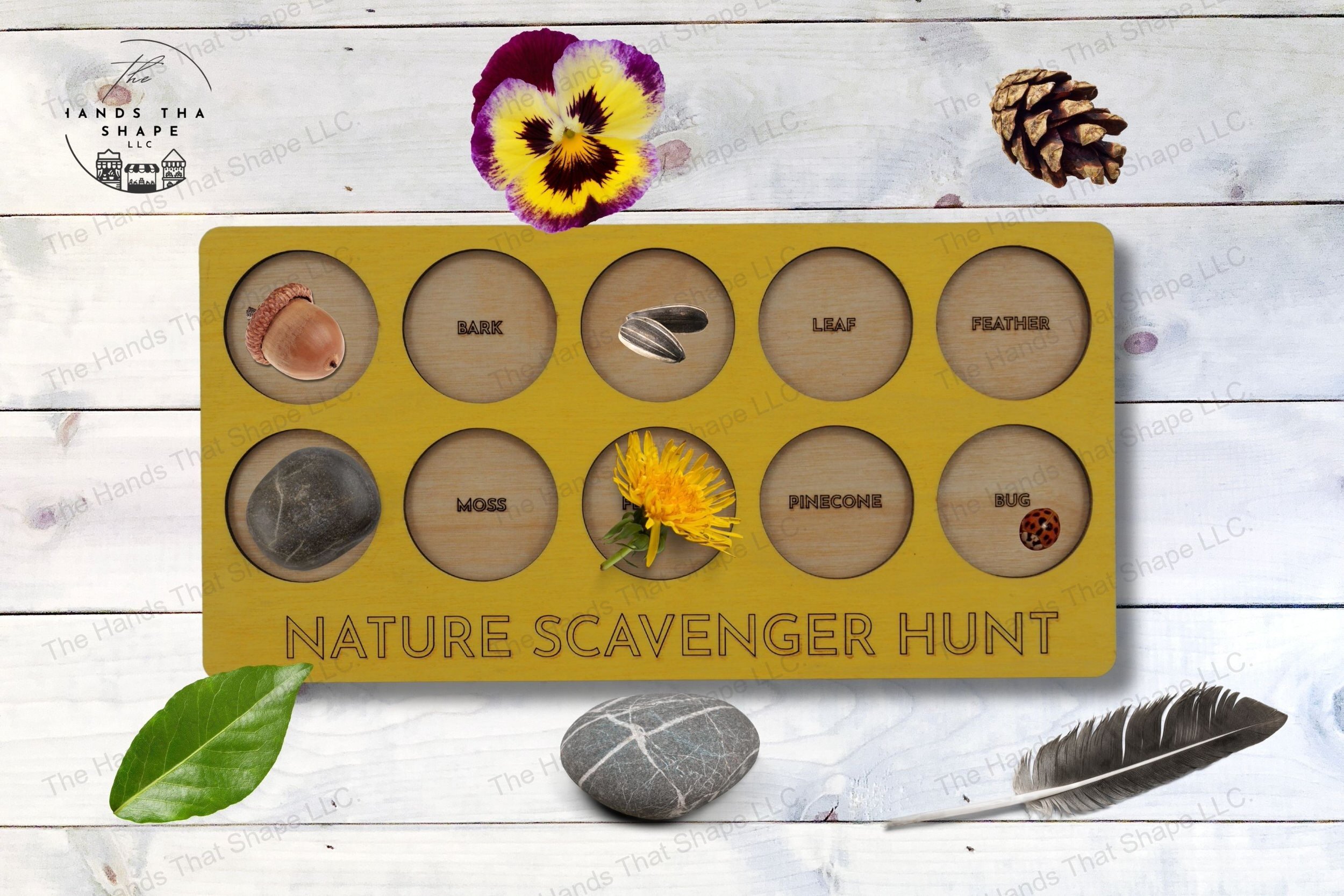 A two-layer wooden activity board featuring ten nature-themed cutouts for kids to search for outdoors, complete with laser marked labels.