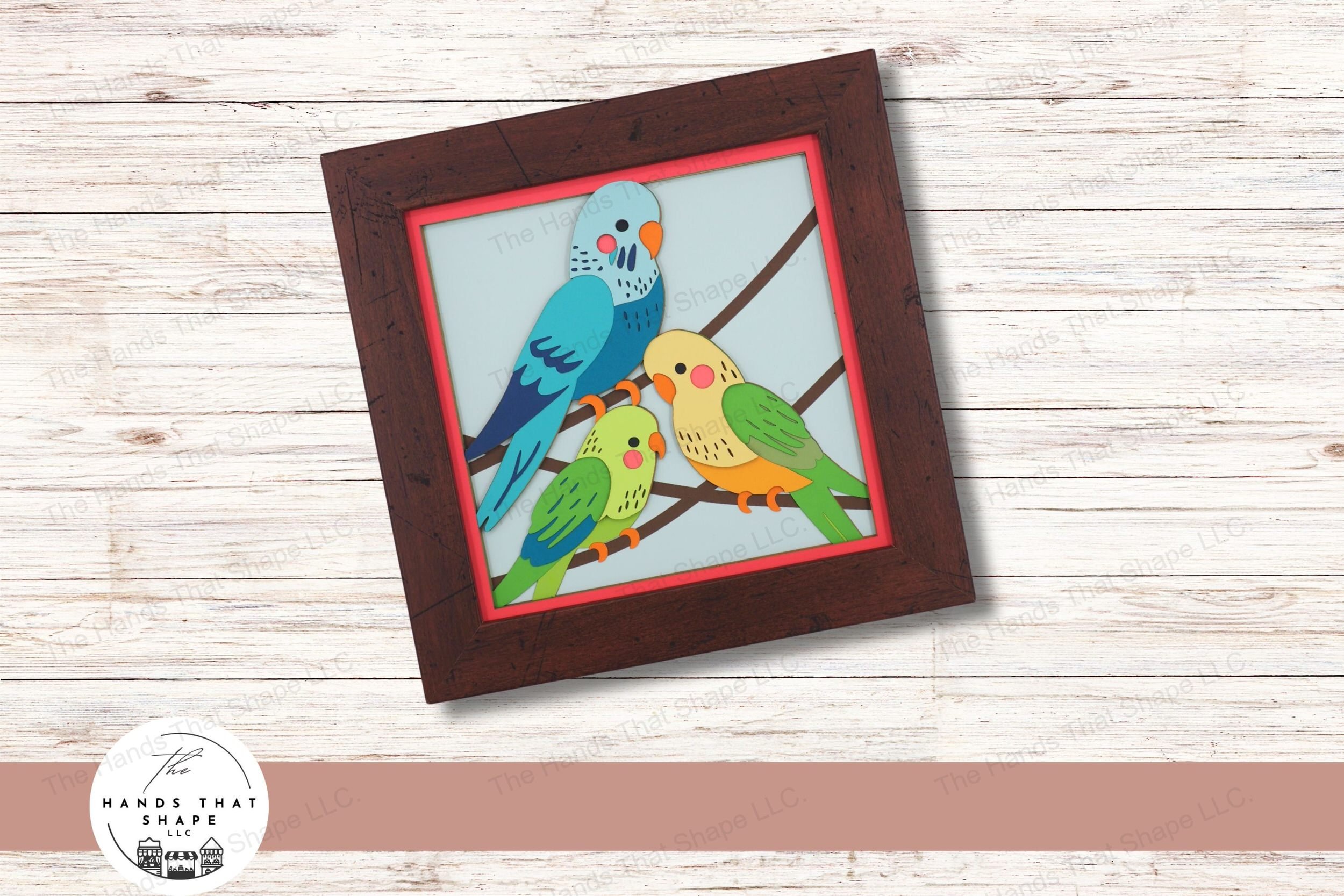 This layered cardstock art piece features 3 colorful parakeets, each bird uniquely detailed in blues, greens, and yellows for a lively and cheerful display.