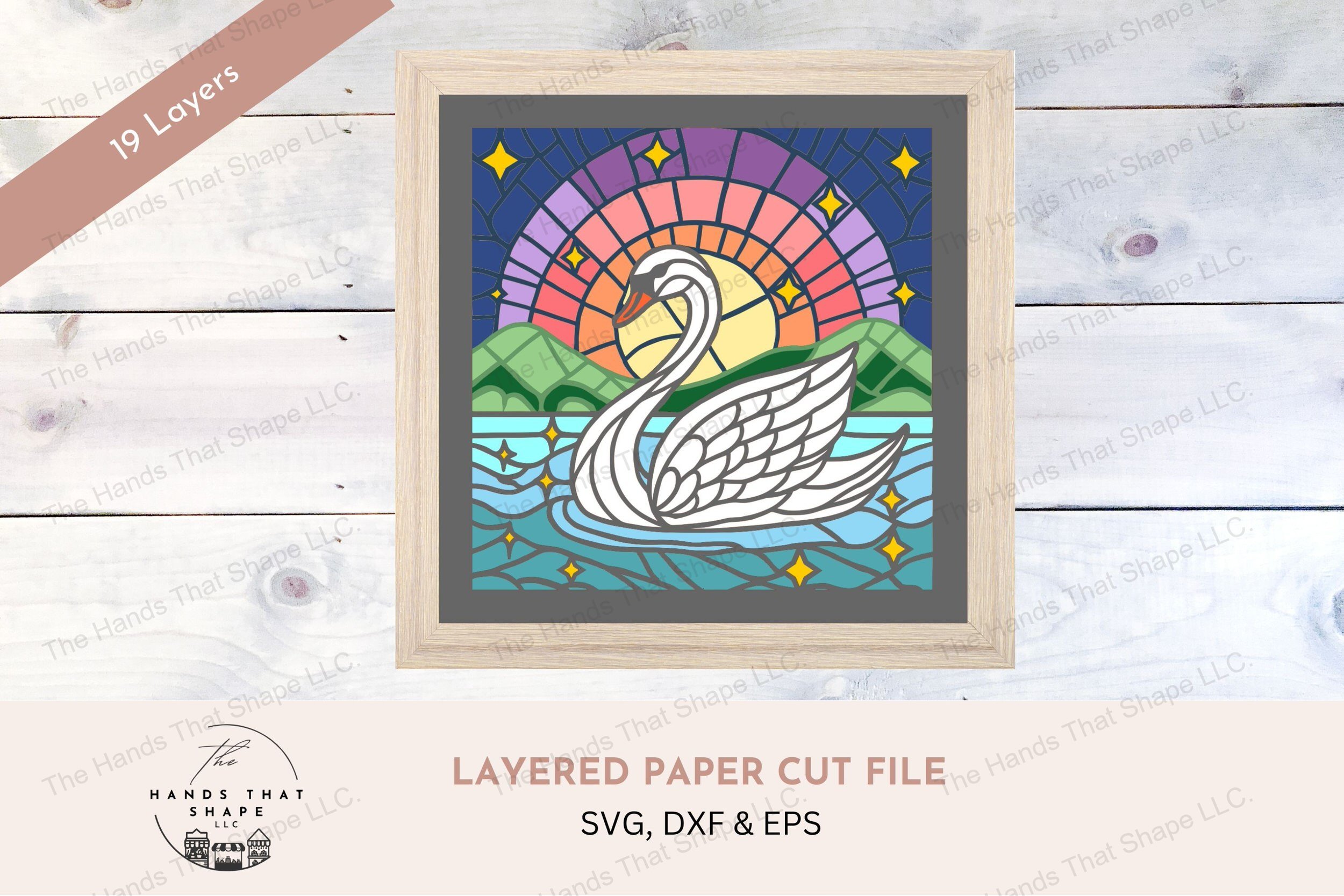This exquisite layered cardstock art piece showcases a serene swan on a lake against a backdrop of a colorful sunrise, enhanced by twinkling stars.
