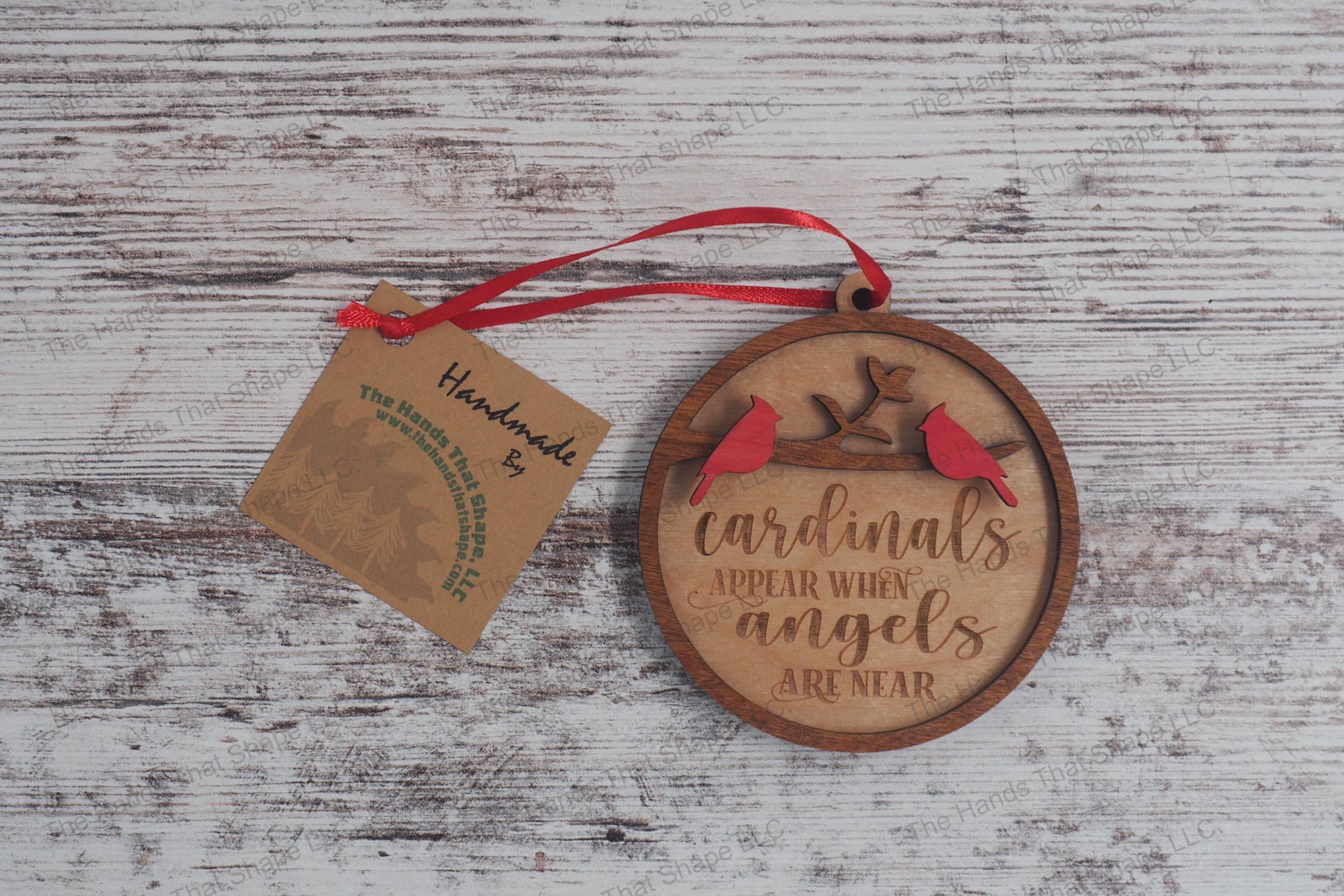 Wooden remembrance ornament featuring the engraved phrase "Cardinals appear when angels are near" along with two cardinals.