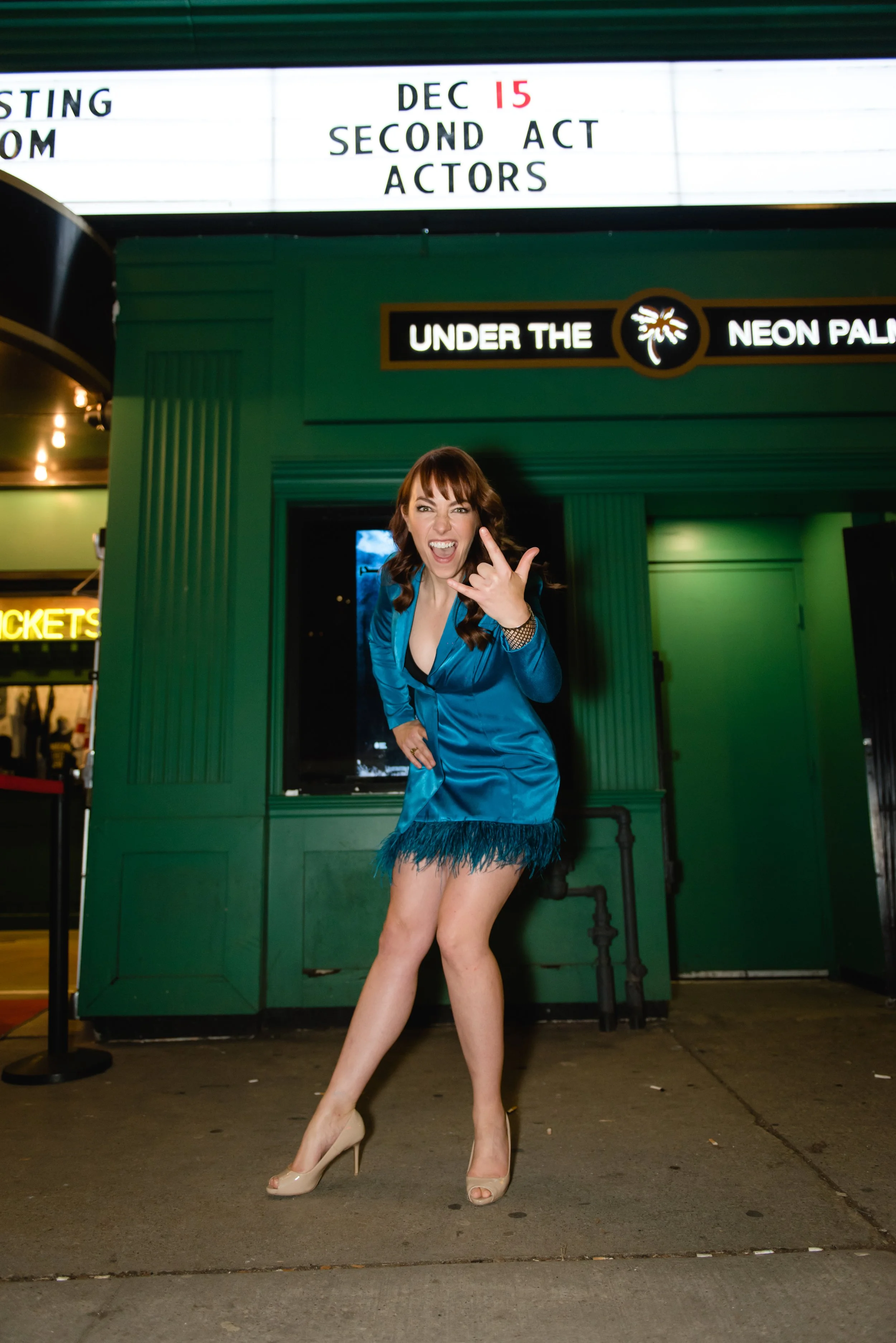 Janet McMordie outside the paradise theatre in a blue feather suit