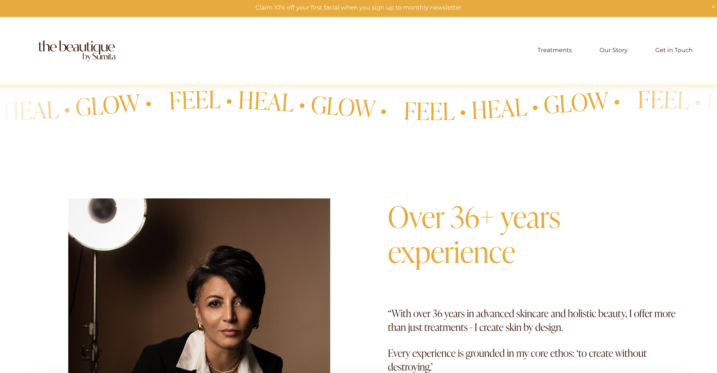 Screenshot of a skincare clinic's homepage, featuring the logo 'the beautique by Sumita,' navigation links 'Treatments,' 'Our Story,' 'Get in Touch,' a promotional banner offering 10% off on a first facial, a repeating slogan 'HEAL GLOW FEEL,' an image of a woman with short dark hair and earrings, and a text block highlighting over 36 years of skincare experience.
