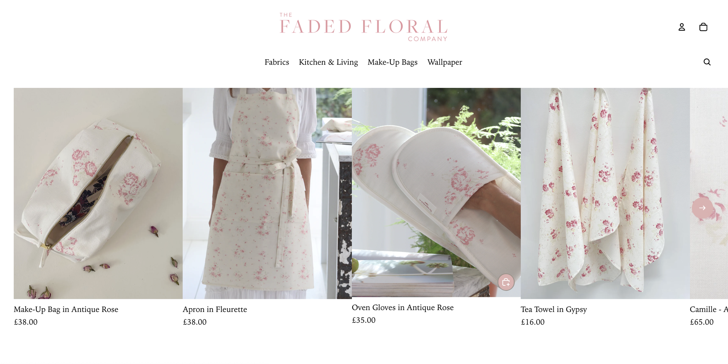 Online shop showcasing floral-themed home and fashion accessories including a makeup bag, apron, oven gloves, tea towels, and a textile product, all featuring a delicate pink antique rose pattern.