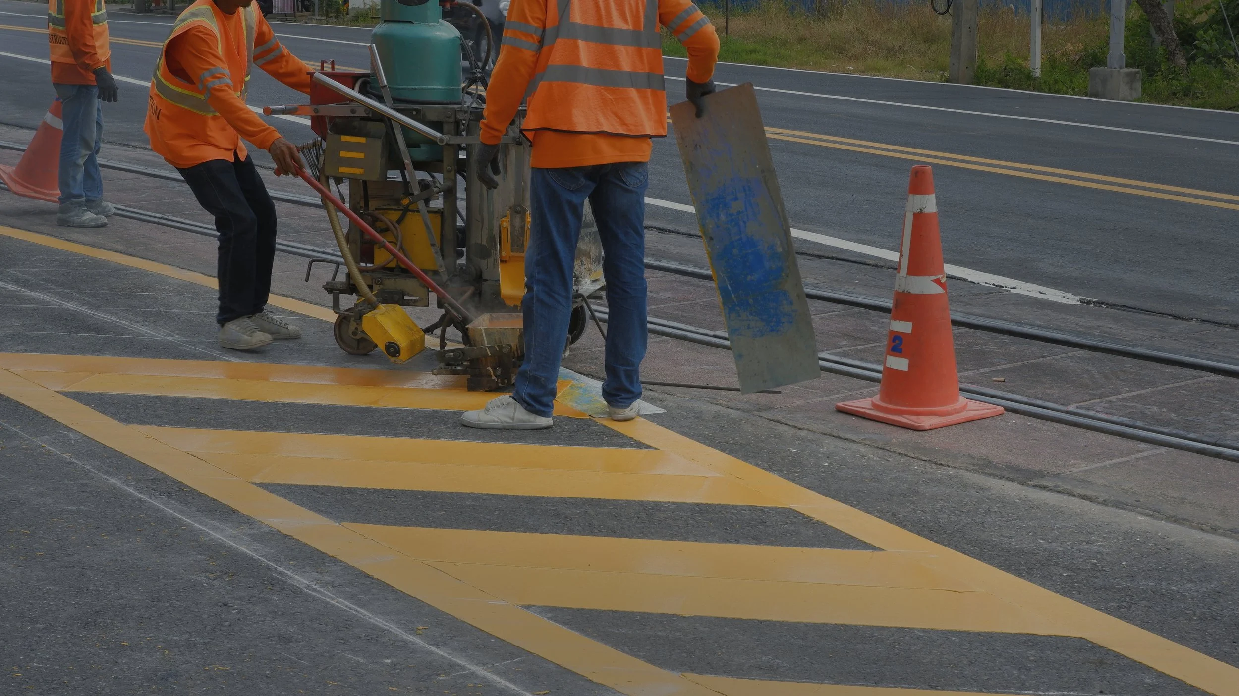 road-workers-with-thermoplastic-marking-machine-are-painting-traffic-yellow-lines-asphalt-road.jpg