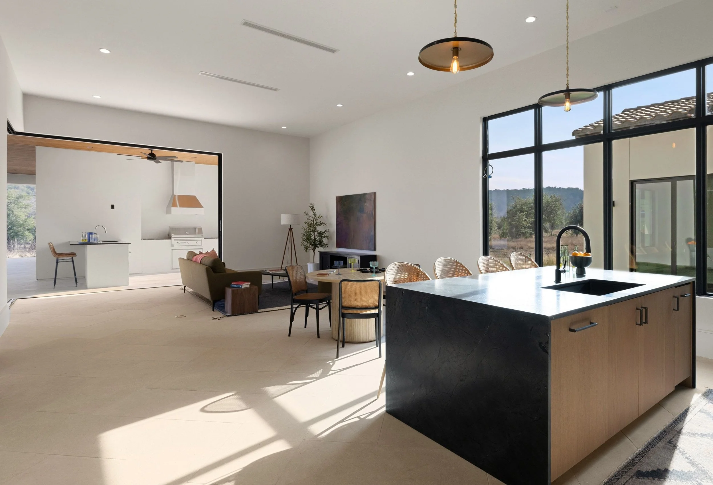 Secondary kitchen with island seating, modern cabinetry, and pendant lighting