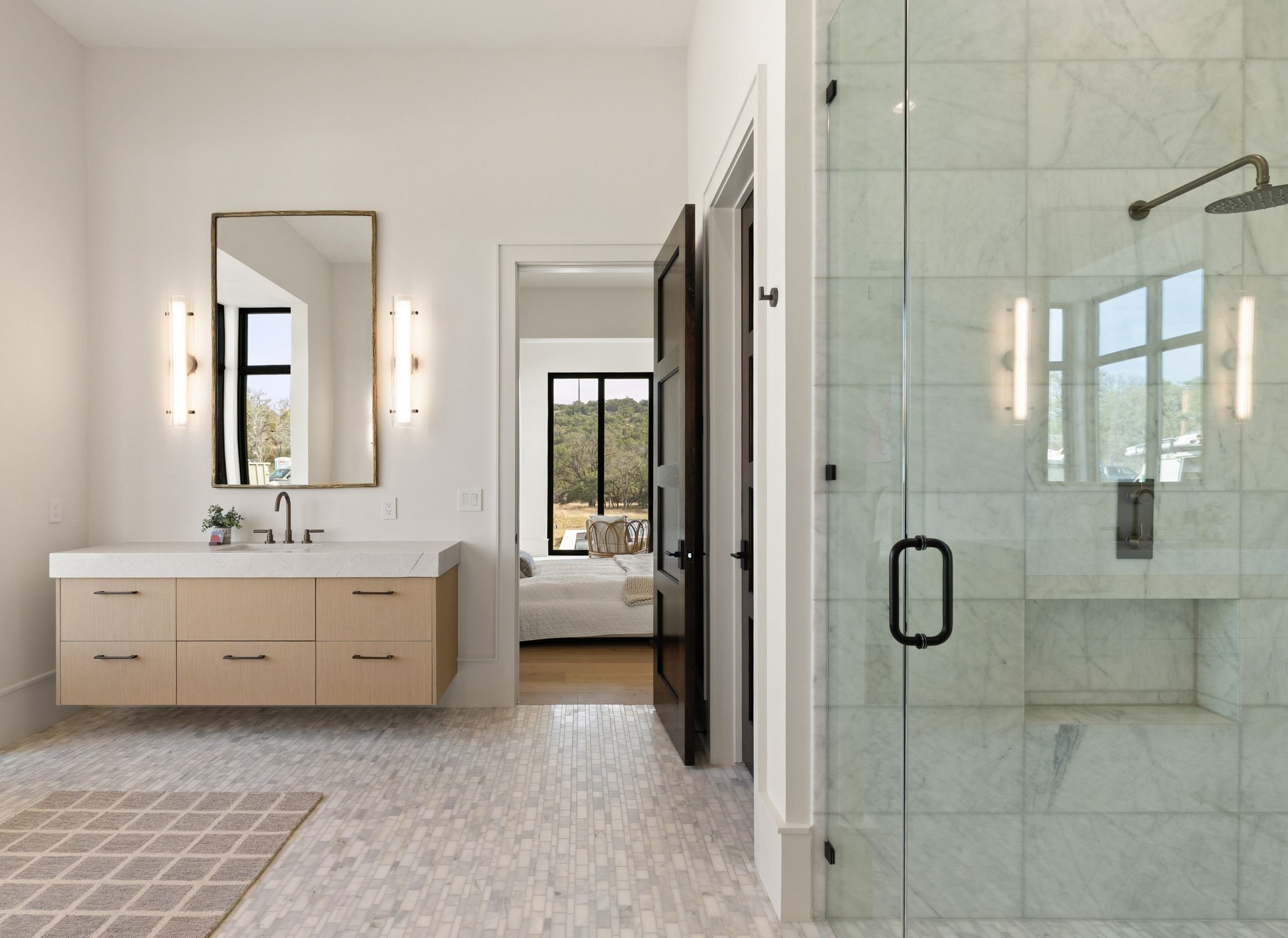 Bathroom with floating vanity, glass shower walls, and modern fixtures
