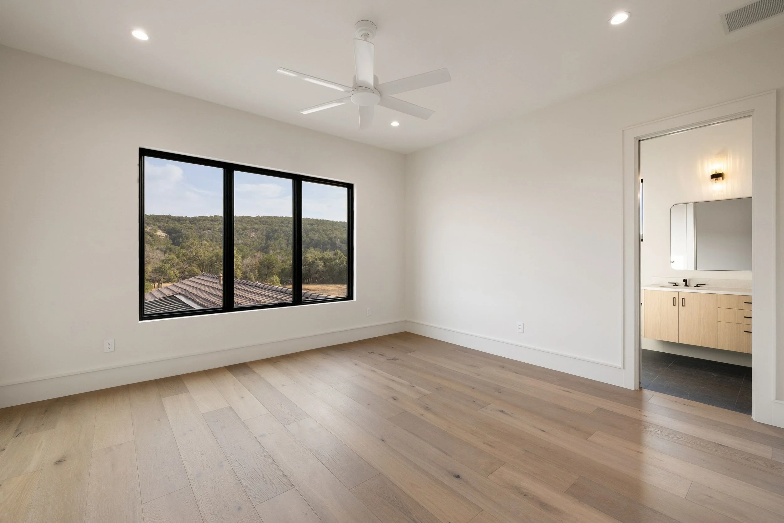 Guest bedroom featuring en suite bathroom and large windows
