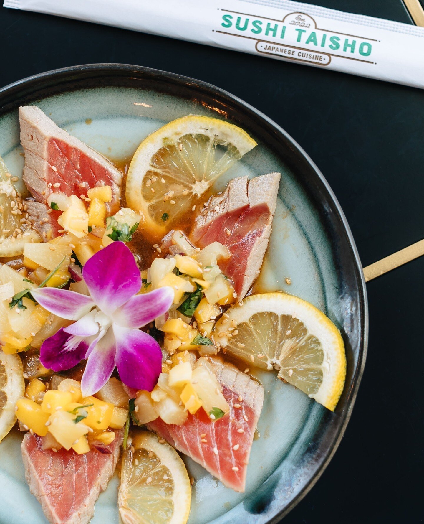 Seared summery perfection ☀️ Enjoy this delicious tuna carpaccio with a side of sunshine on our gorgeous outdoor patio!!! Only at Sushi Taisho 🥢🌟⁠
⁠
Seared Tropical Sunset Carpaccio: 6 pieces of seared tuna topped with mango, pineapple, jalapeno, a