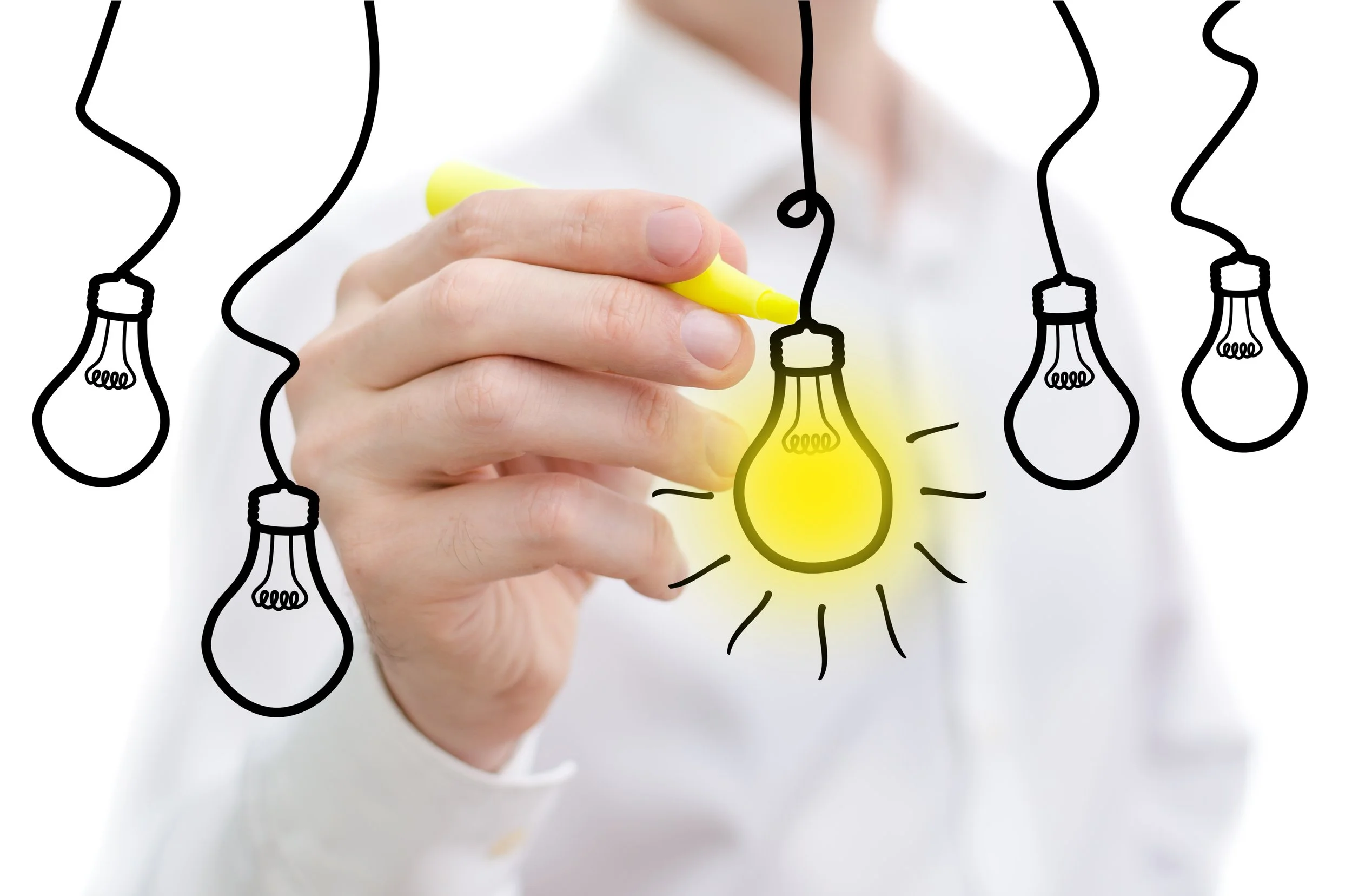 A man standing behind a row of illustrated lightbulbs as he colors one in with a yellow highlighter.