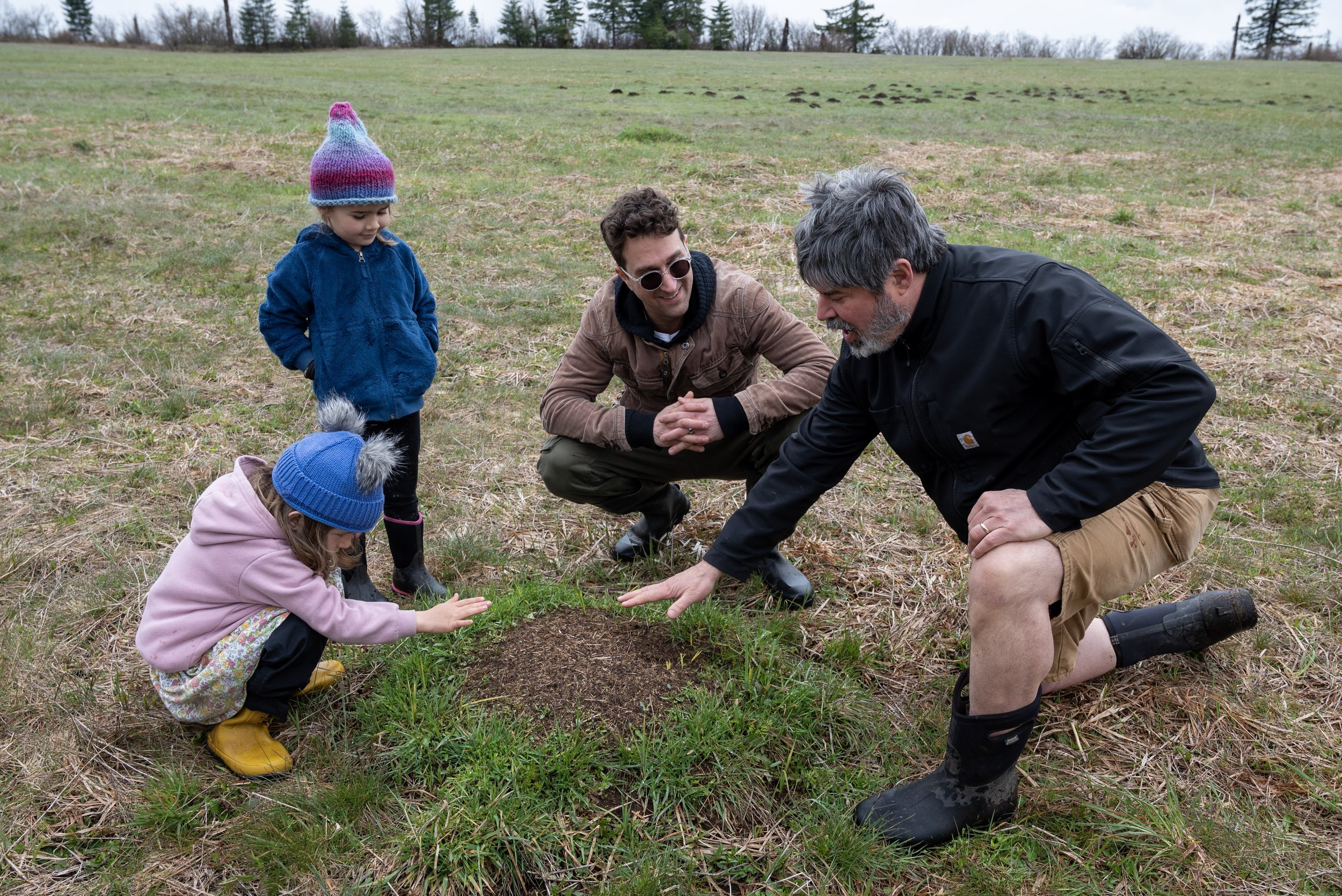 Two adults and two children exploring the Land