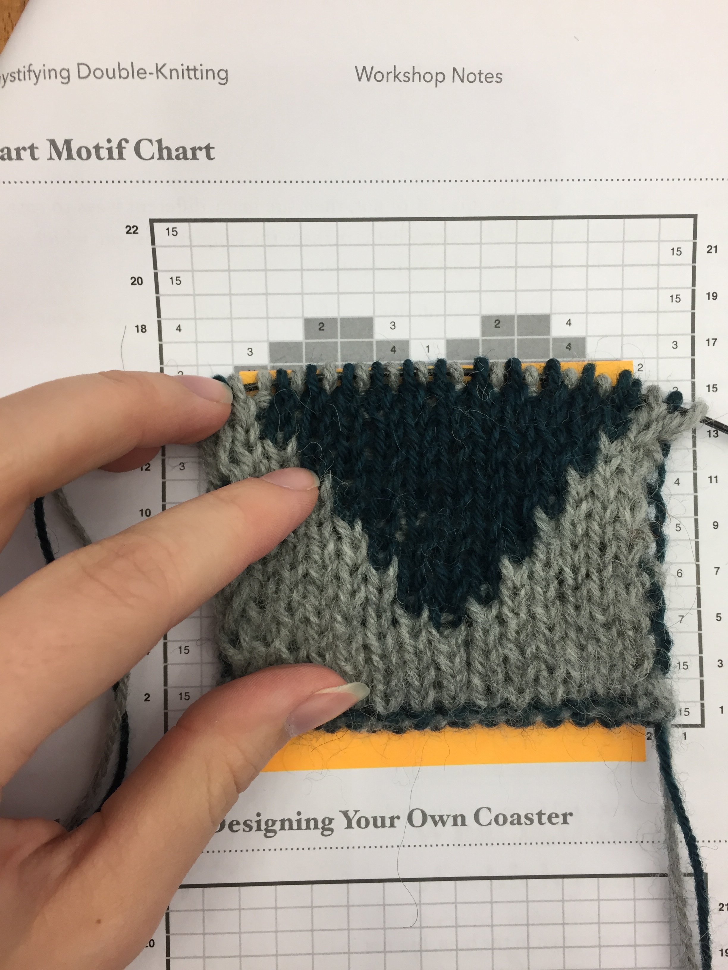 Learning to double knit by knitting a swatch with a heart motif.