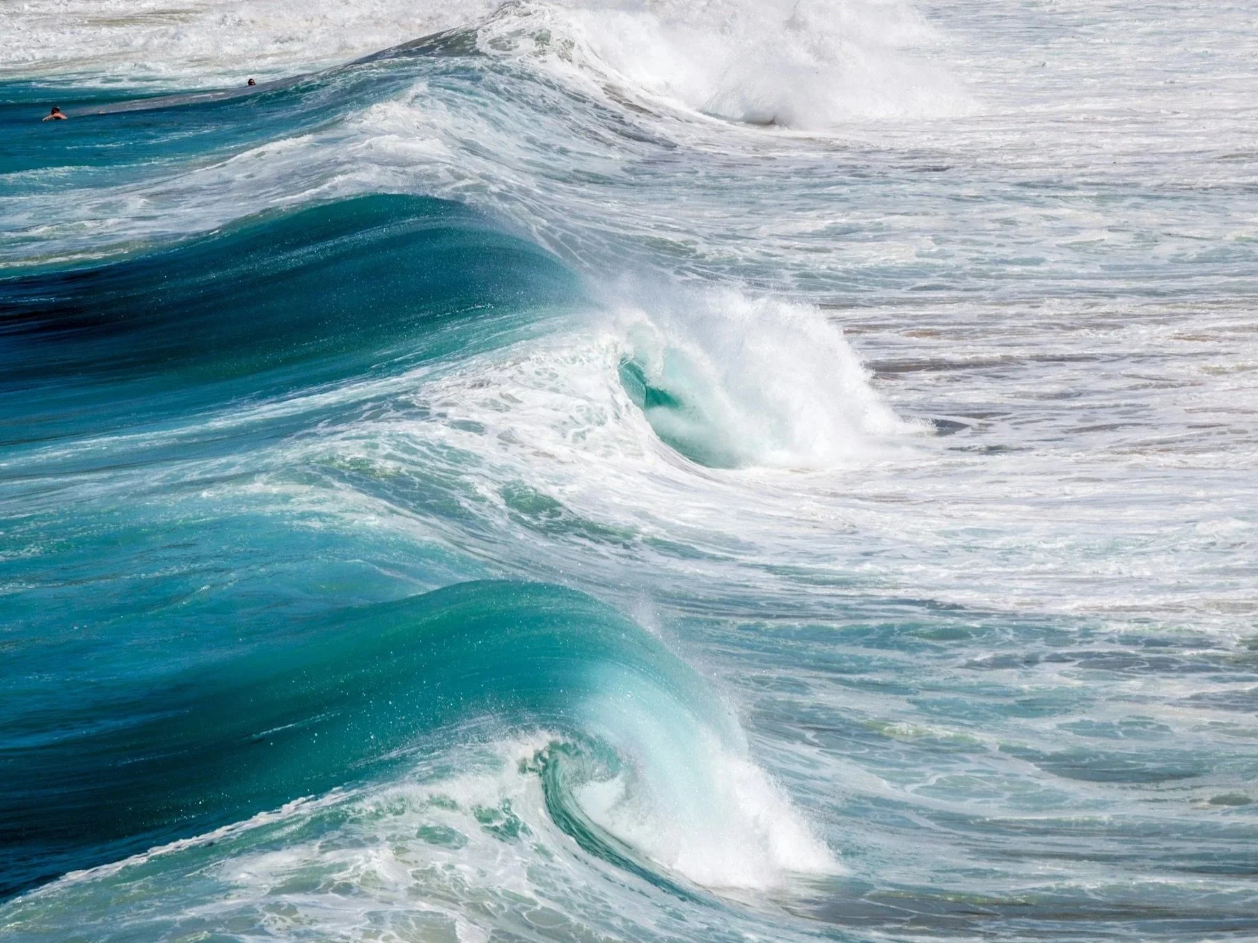 Rolling ocean waves moving rhythmically across the sea, creating a sense of movement and flow.