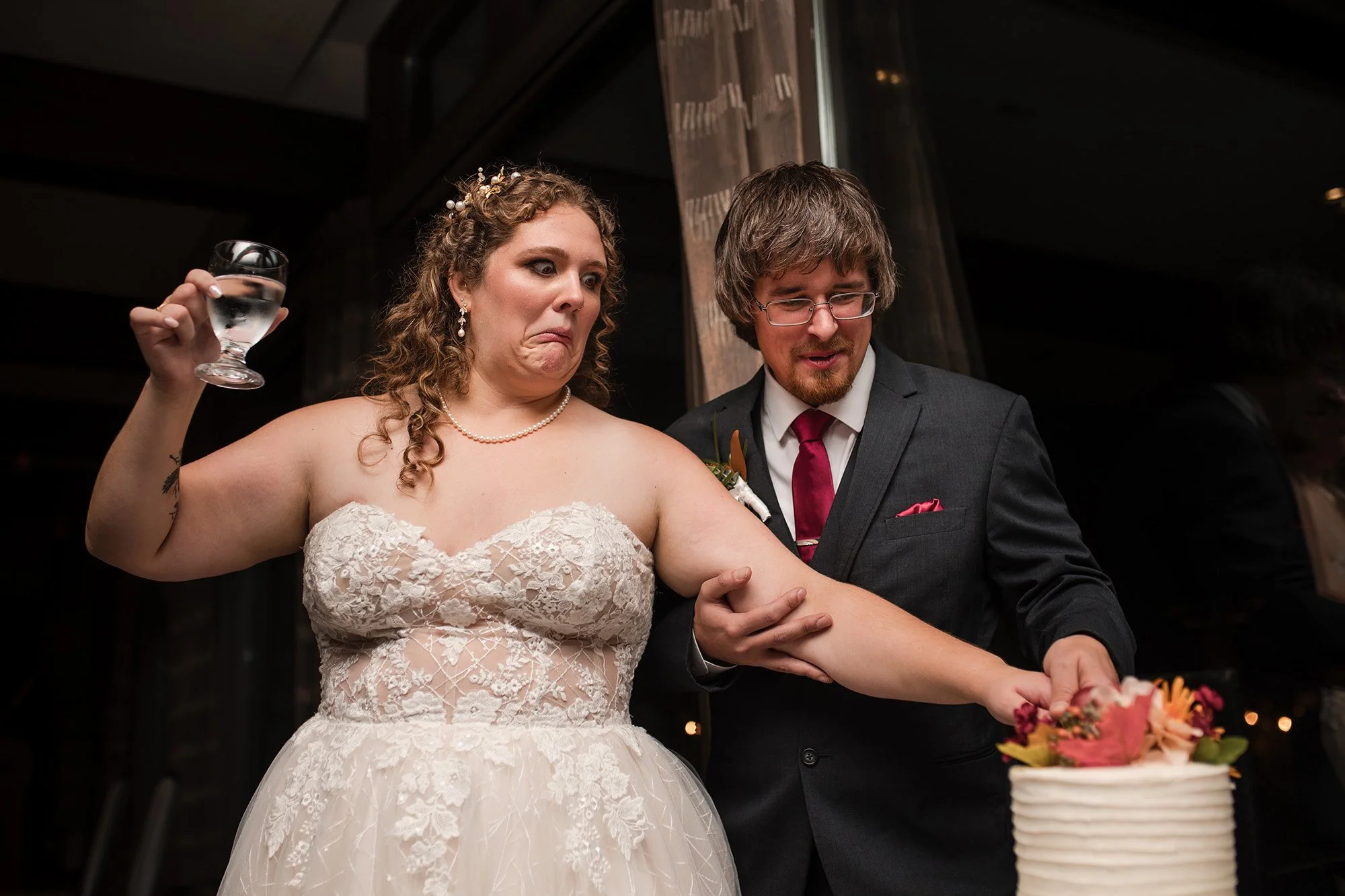 Bride makes a funny face during cake cutting at the Edmonton Golf and Country Club 