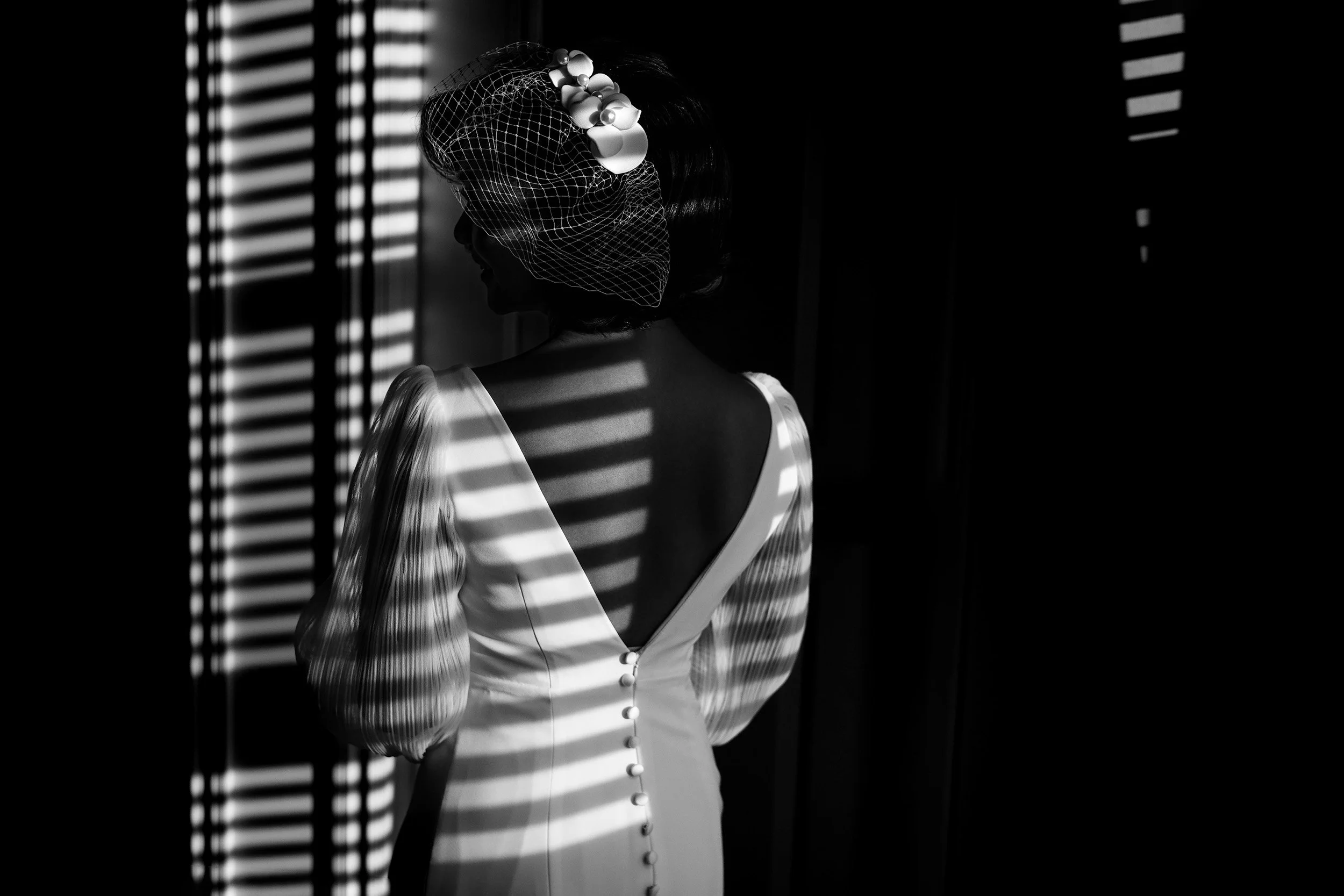 Window light creates interesting pattern on bride back during Edmonton Wedding 