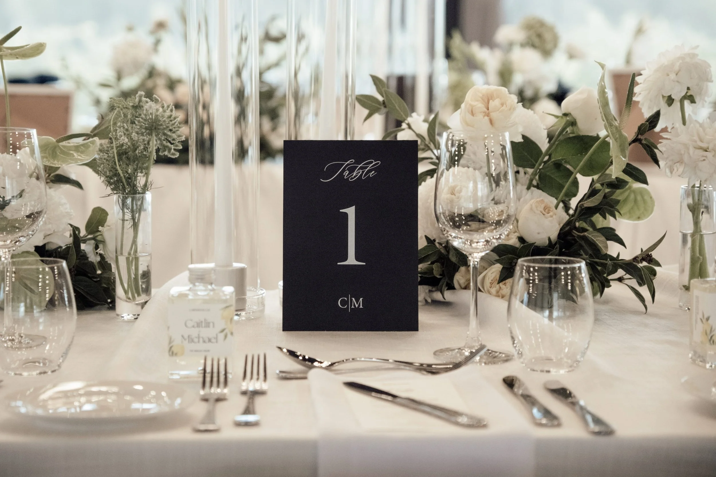 Circular bridal table styled with white linen, and contemporary tableware and florals at Nikola Estate Pavilion.