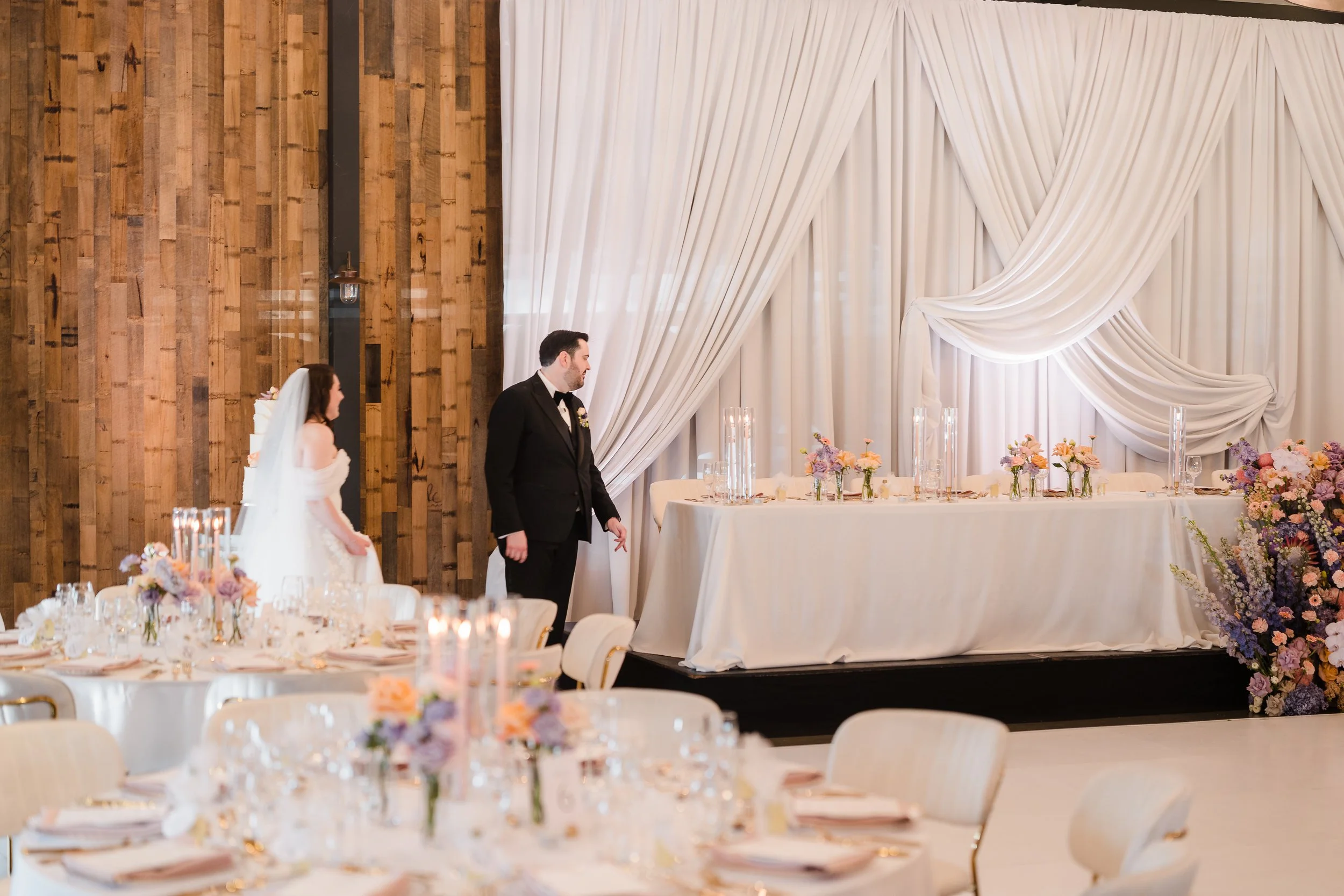 Bride and groom first look at reception in Sandalford Estate Room, pastel, elegant, romantic styling with white drapped bridal table backdrop