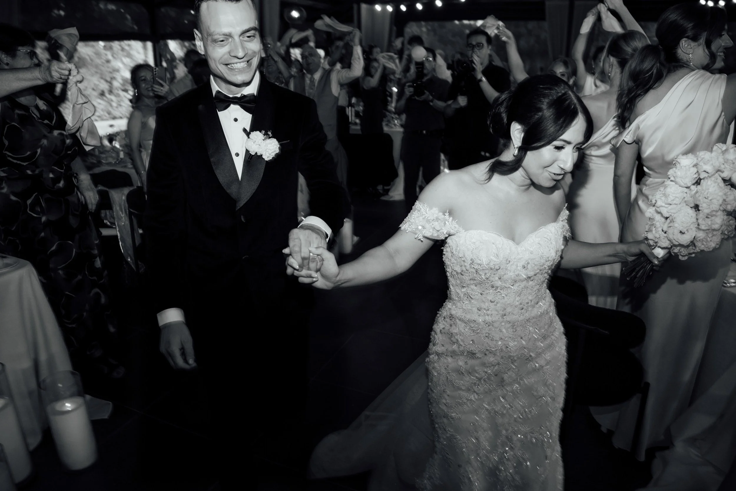 Newlyweds entering their modern wedding reception in Nikola Estate Pavillion reception styled by Refine Events.