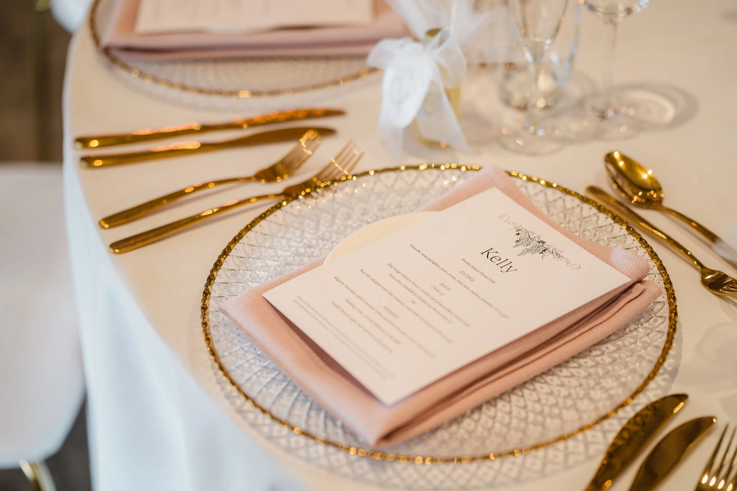 Gold-accented wedding table styling with blush napkins, white custom menu with vine illustration at Sandalford Estate, Swan Valley