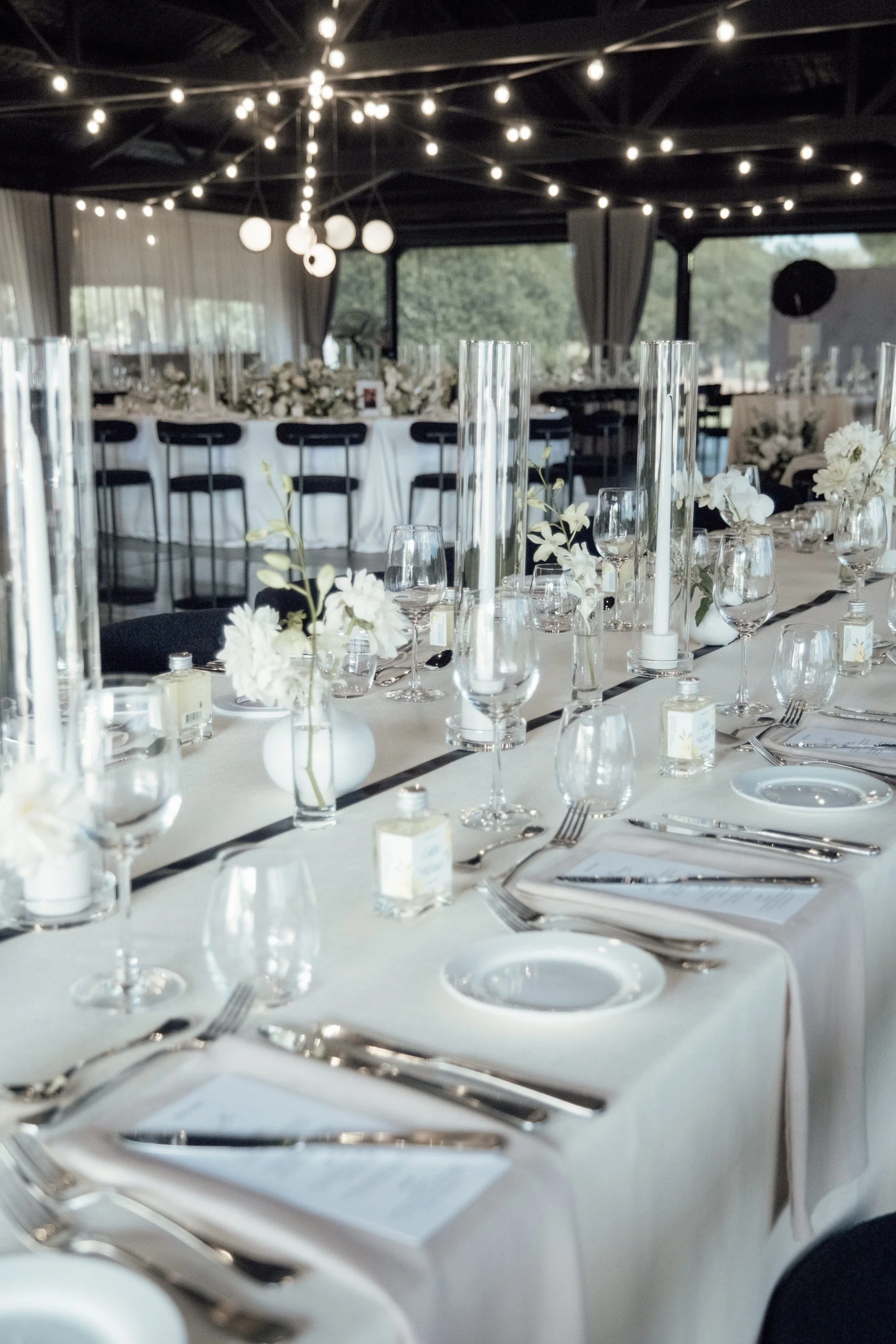 Reception guest table styled with layered textures and modern place settings.