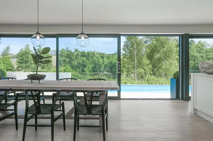 BRP Architects — Bespoke house open plan dining kitchen area with swimming laps pool outside