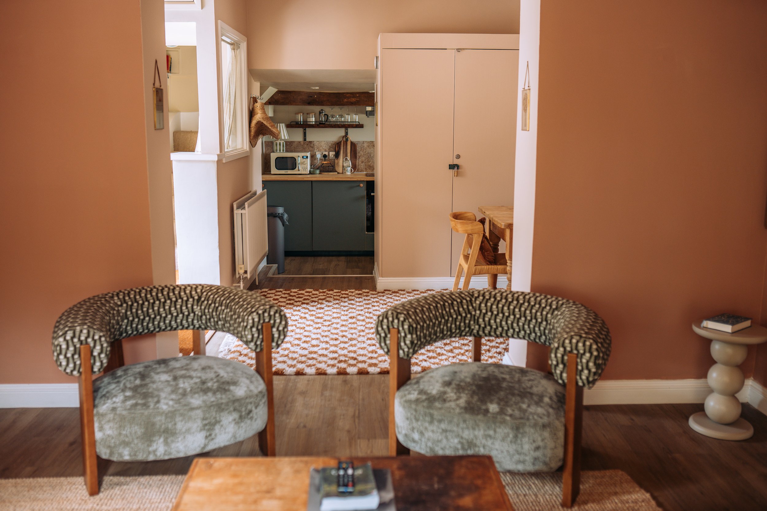 Armchairs with view through to the kitchen at Church Farm Estate