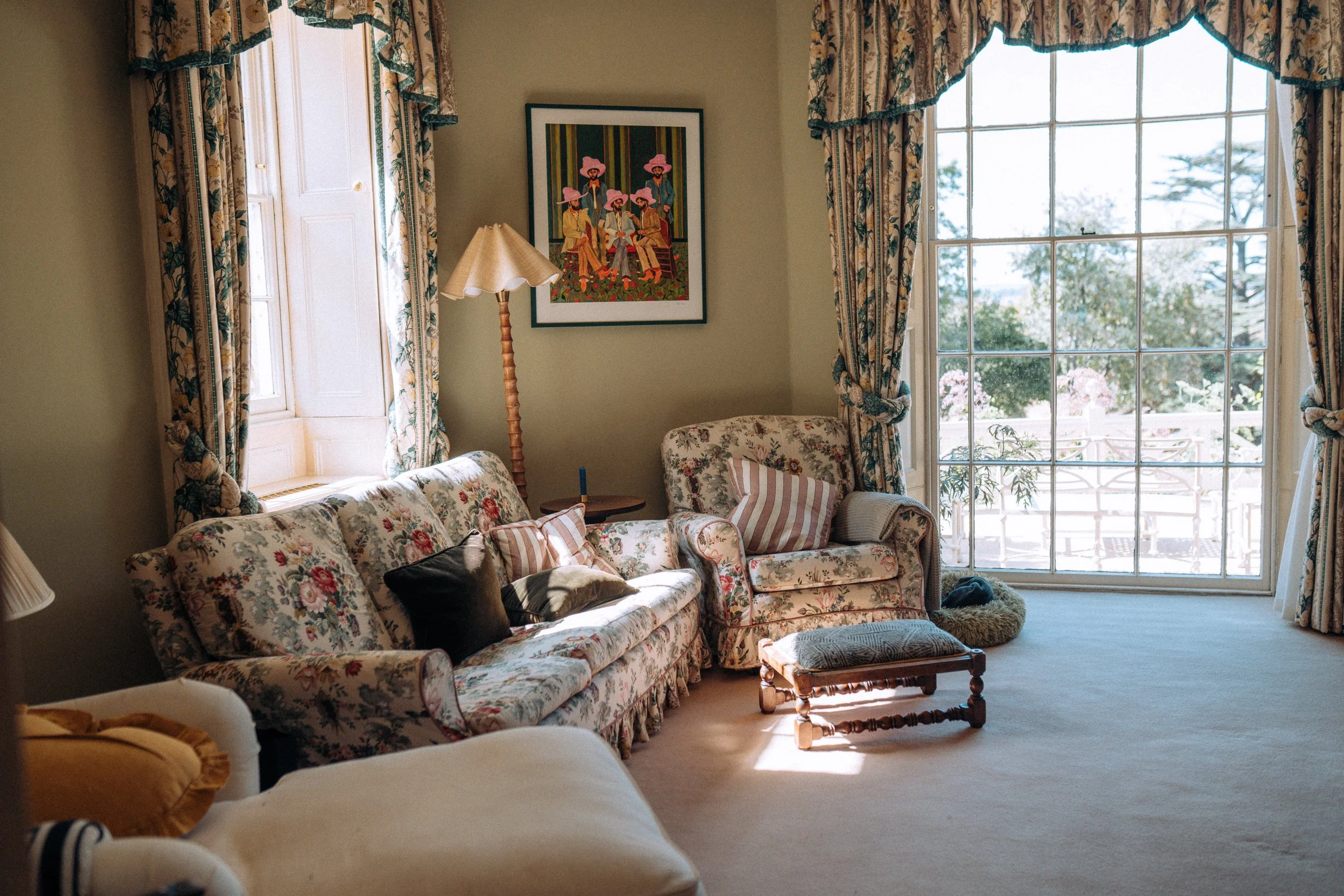 Sunlit drawing room with floral sofas at Friars Well, Aynho