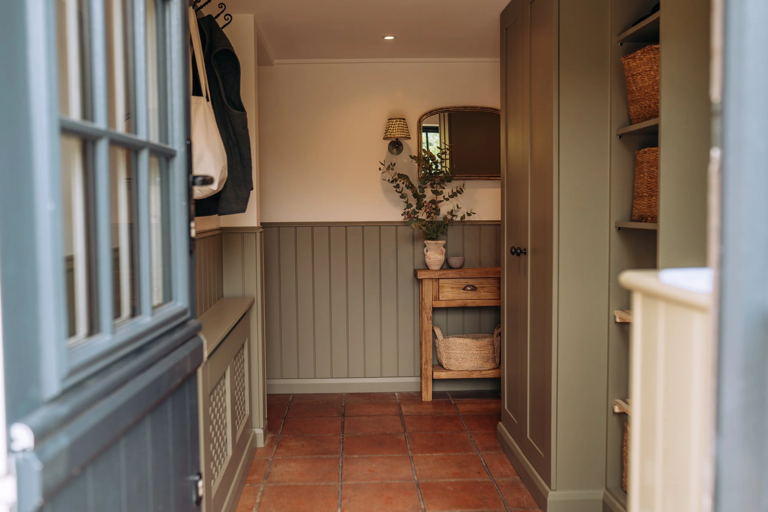 Sage green panelled boot room, East Knoyle, Wiltshire